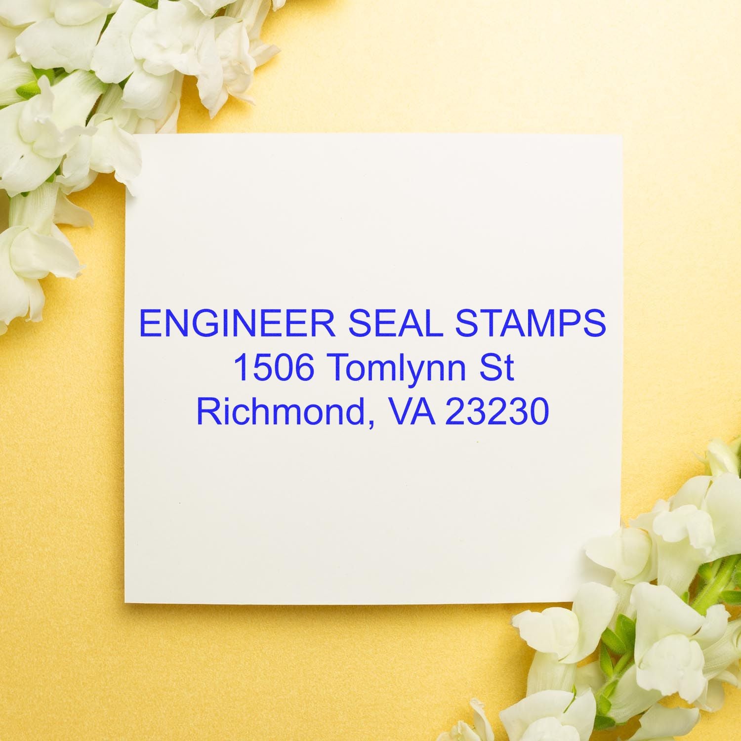 3 Line Self Inking Address Stamp used on a white card with text ENGINEER SEAL STAMPS, 1506 Tomlynn St, Richmond, VA 23230 on a gold background with flowers.