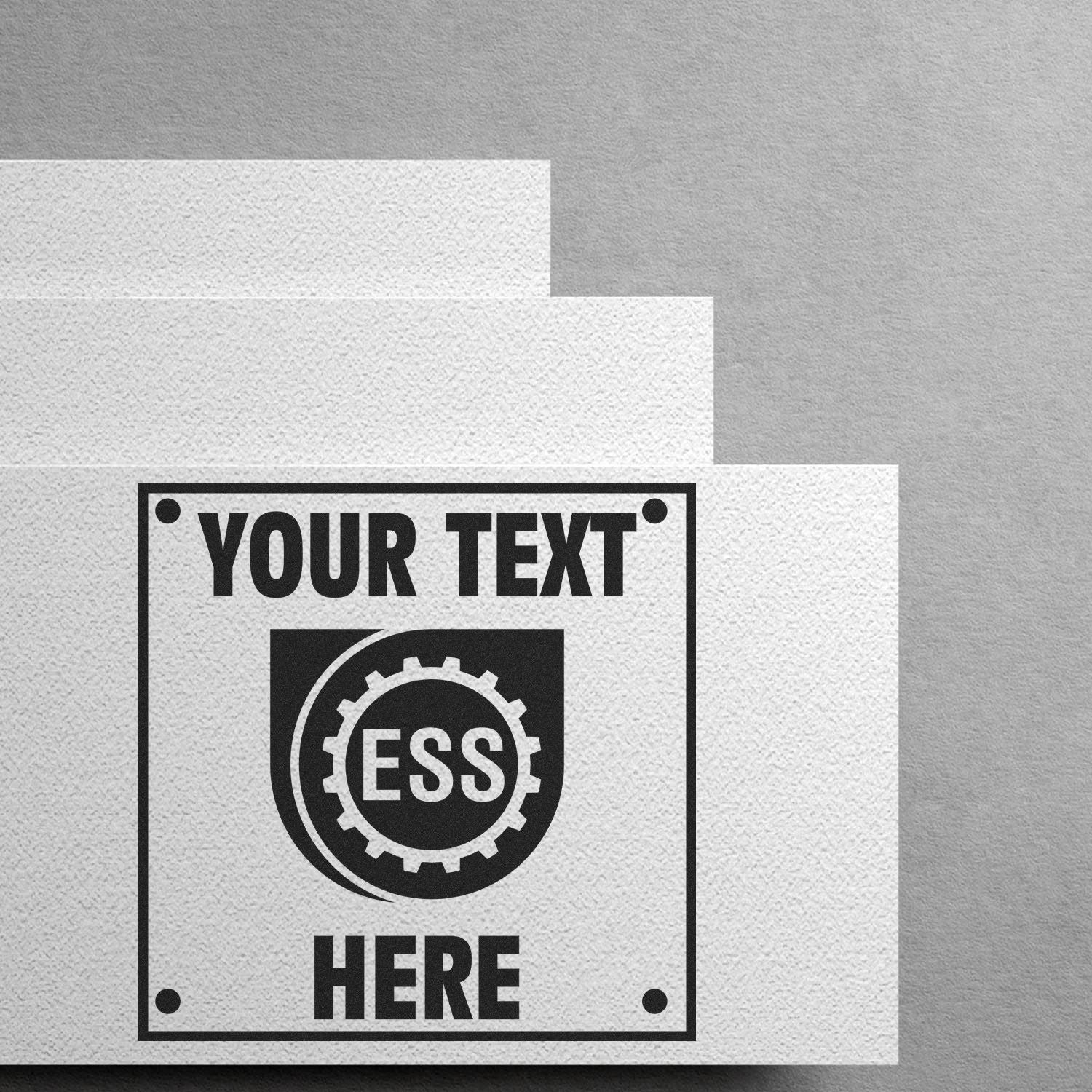 Custom Rubber Stamp Size 1 x 1 in use, stamping YOUR TEXT HERE on white paper with a gray background.