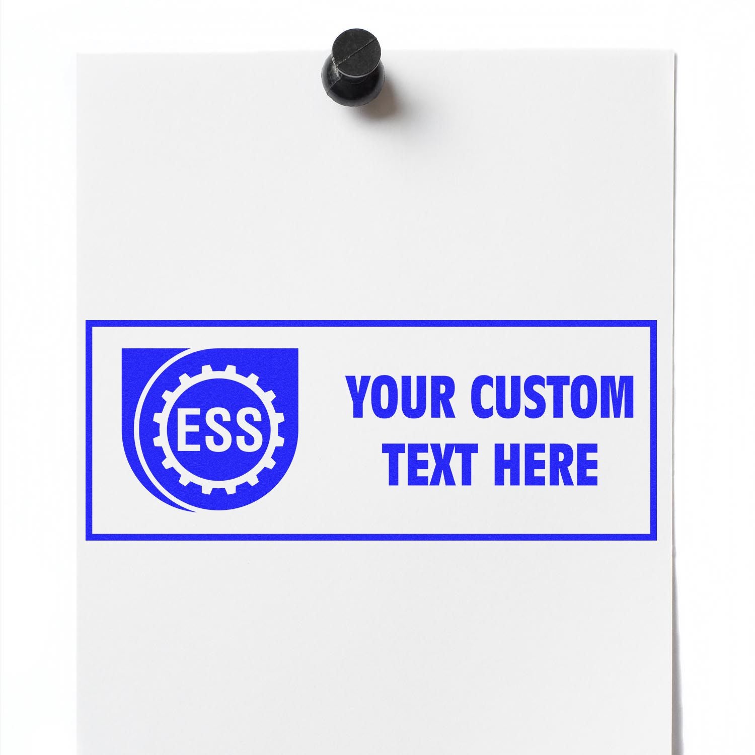 Custom Rubber Stamp Size 1 x 2 with blue ESS logo and Your Custom Text Here on white paper pinned to a board.