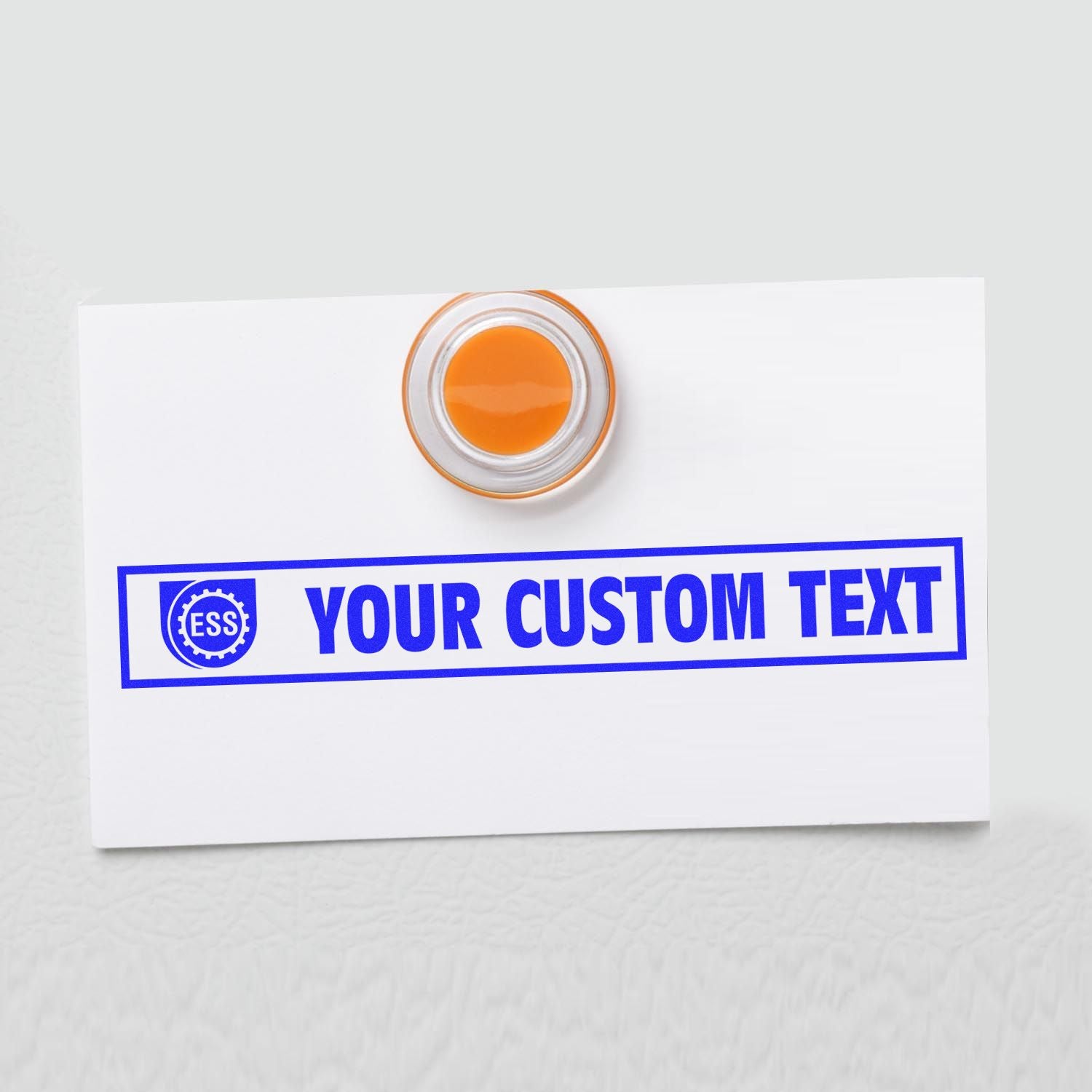 Custom Rubber Stamp Size 1 x 10 with YOUR CUSTOM TEXT in blue ink on a white card, featuring an orange handle.