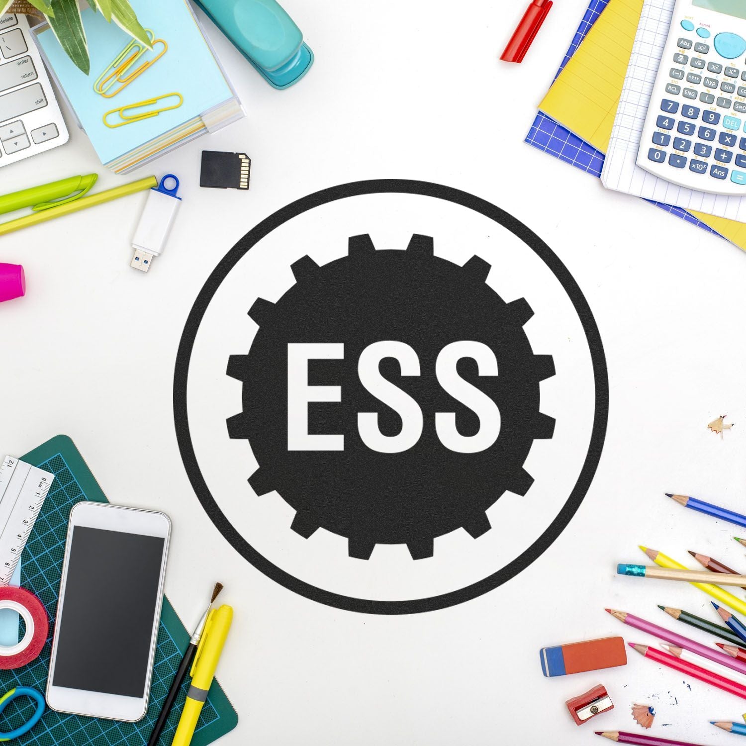 Desk with office supplies and a Custom Rubber Stamp Size 1/2 Inch Diameter featuring the ESS logo in the center.