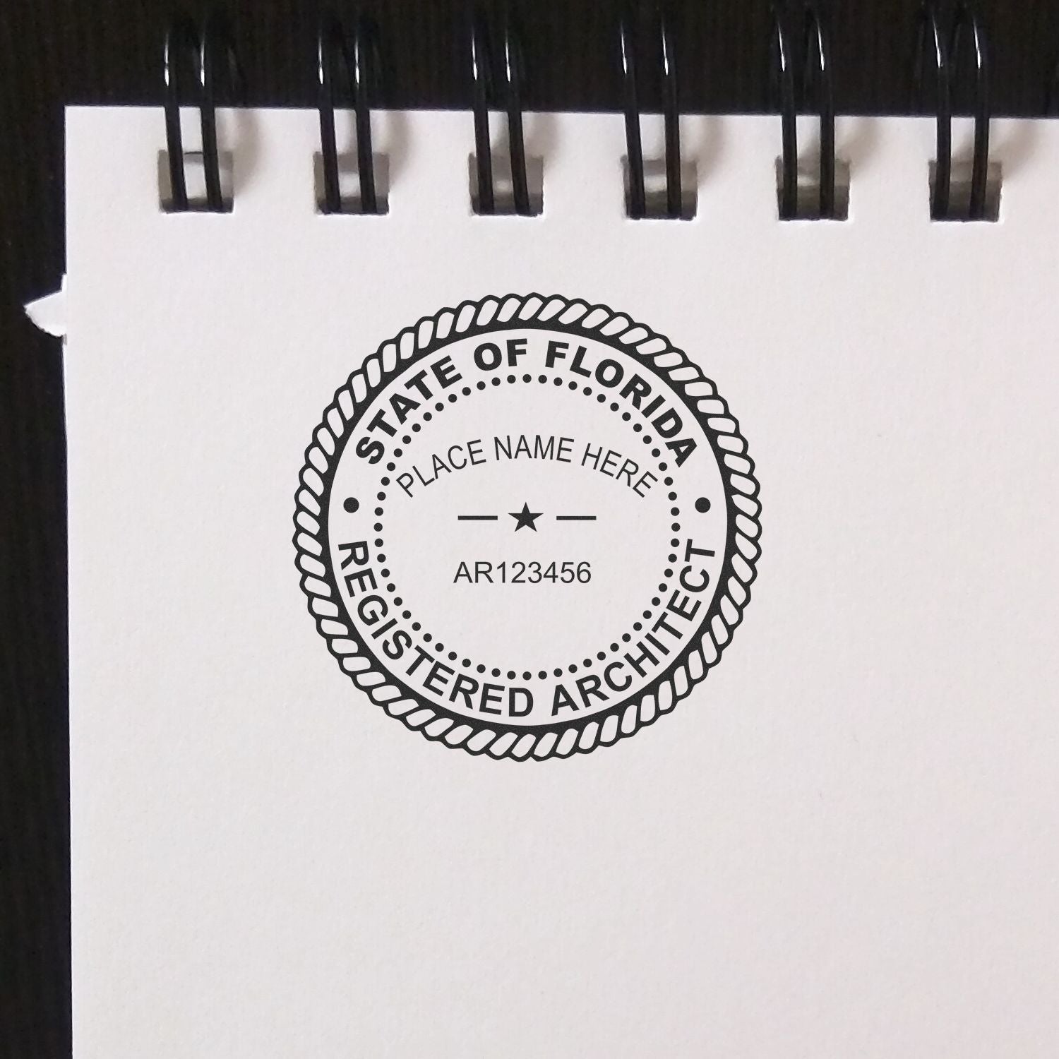 Florida Architect Seal Stamp on a white notepad, displaying State of Florida Registered Architect with a placeholder for name and license number.