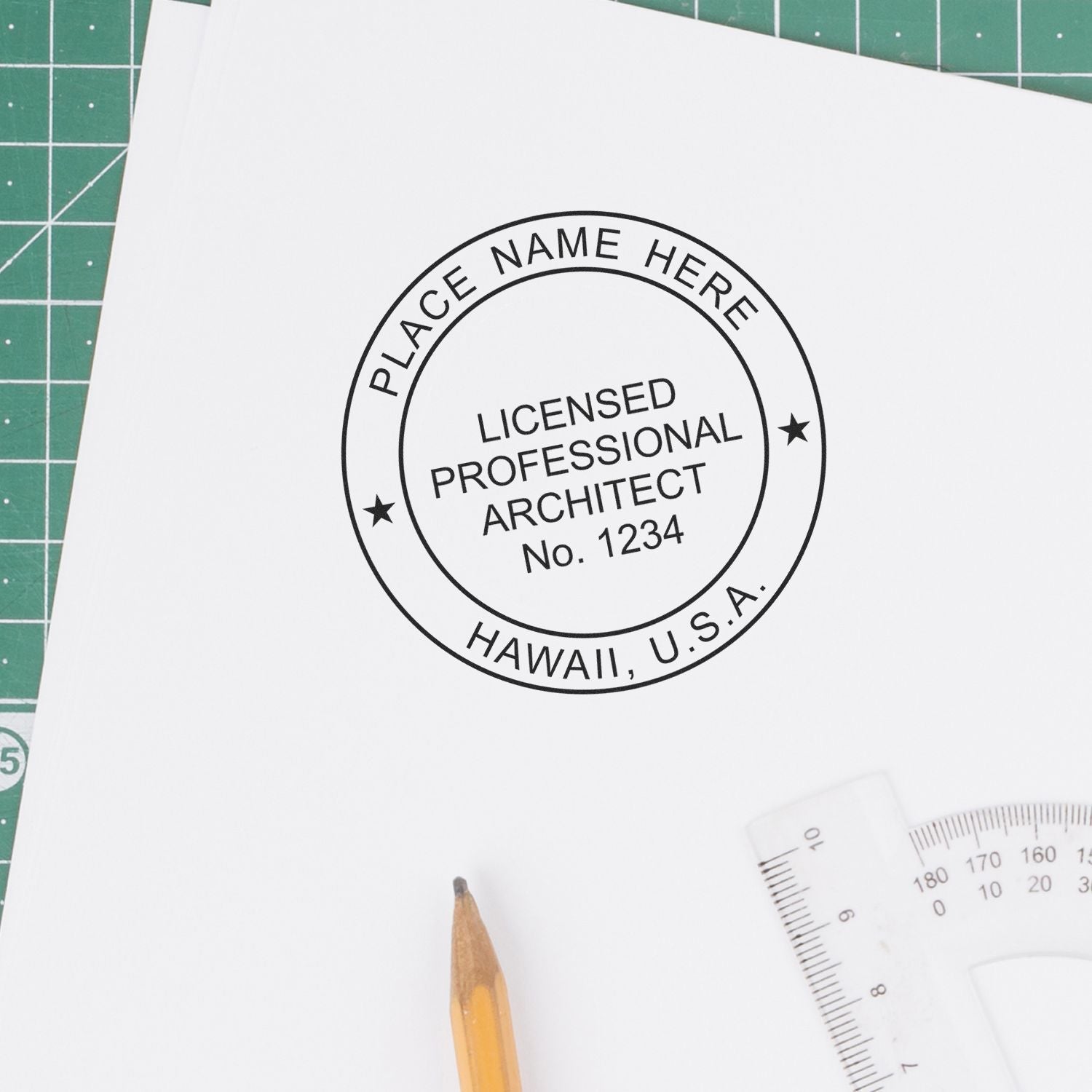 Hawaii Architect Seal Stamp on white paper with pencil, ruler, and green cutting mat in the background.