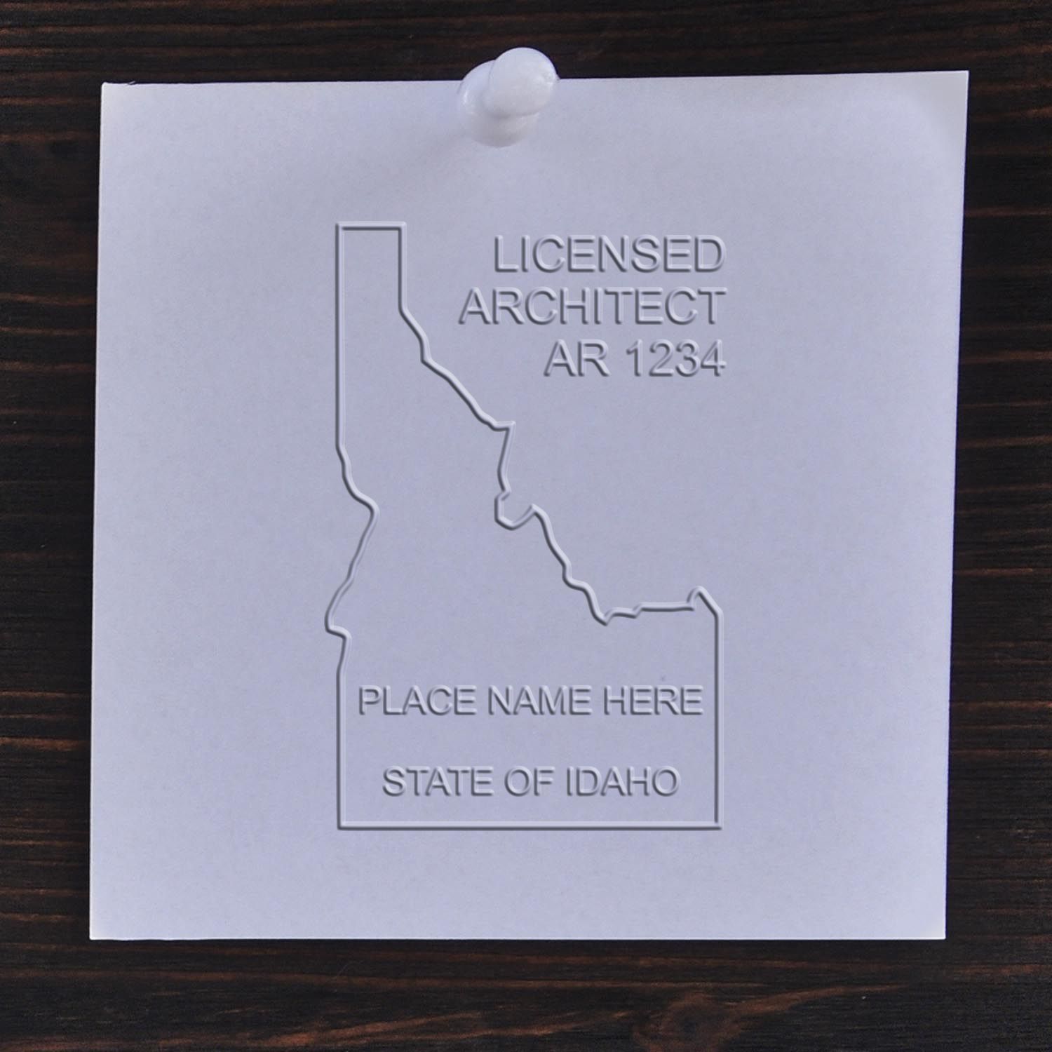 A stamped impression of the State of Idaho Architectural Seal Embosser in this stylish lifestyle photo, setting the tone for a unique and personalized product.