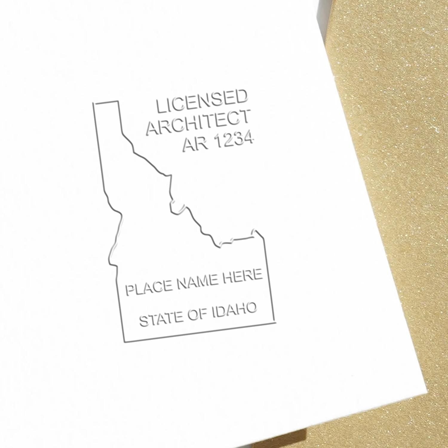 Extended Long Reach Idaho Architect Seal Embosser in use photo showing a stamped imprint of the Extended Long Reach Idaho Architect Seal Embosser