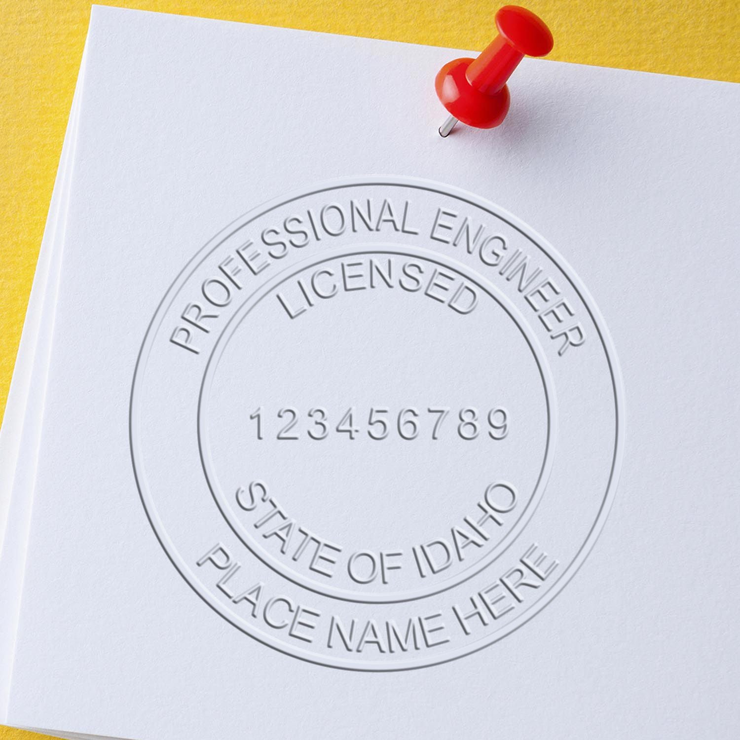 A stamped impression of the Handheld Idaho Professional Engineer Embosser in this stylish lifestyle photo, setting the tone for a unique and personalized product.