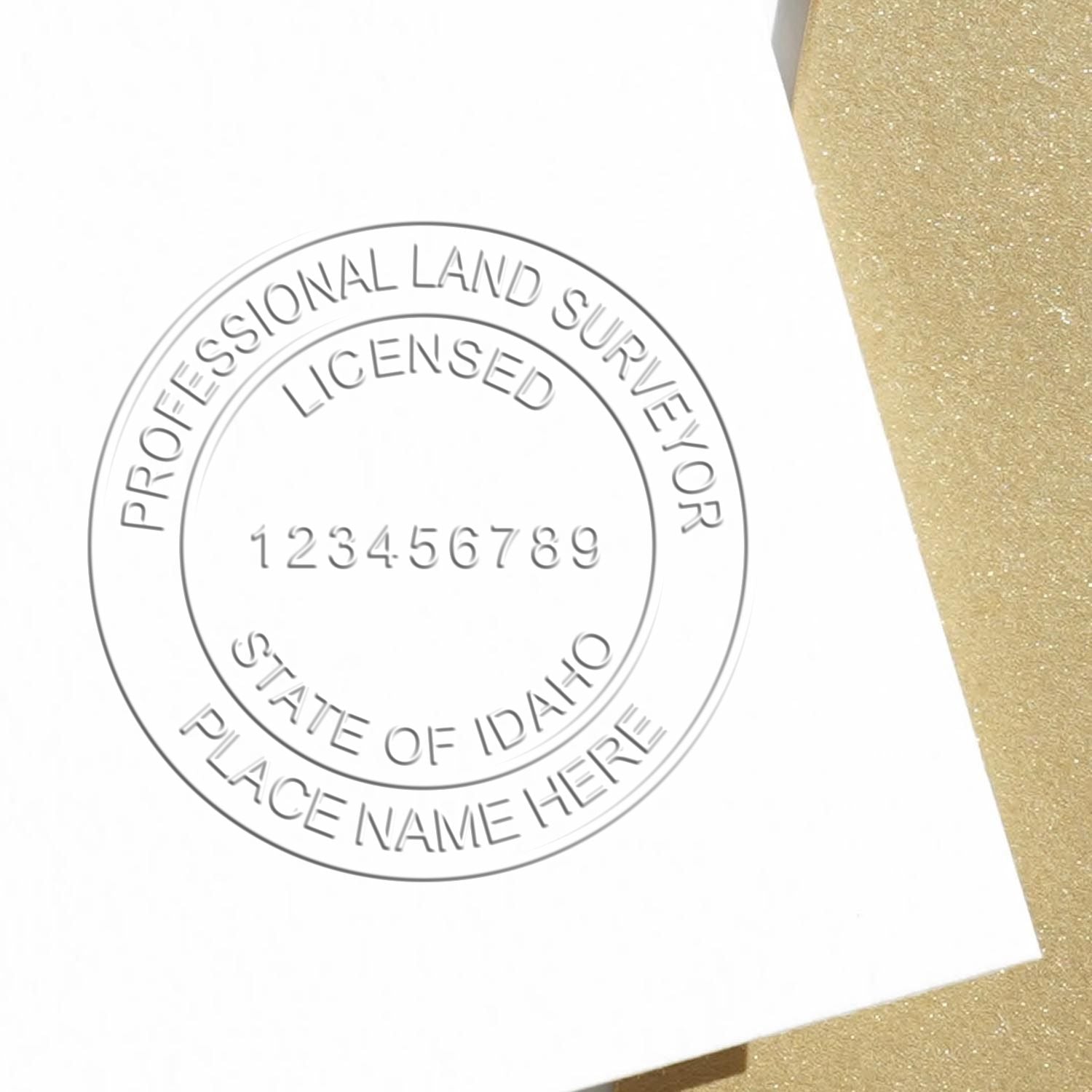 A lifestyle photo showing a stamped image of the State of Idaho Soft Land Surveyor Embossing Seal on a piece of paper