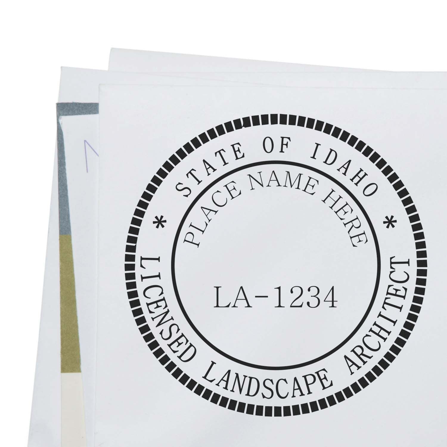 A lifestyle photo showing a stamped image of the Digital Idaho Landscape Architect Stamp on a piece of paper