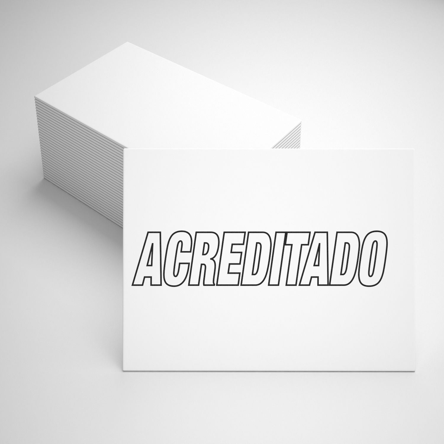 A stack of white cards with one card on top displaying the word ACREDITADO in bold, black letters, next to an Acreditado rubber stamp.