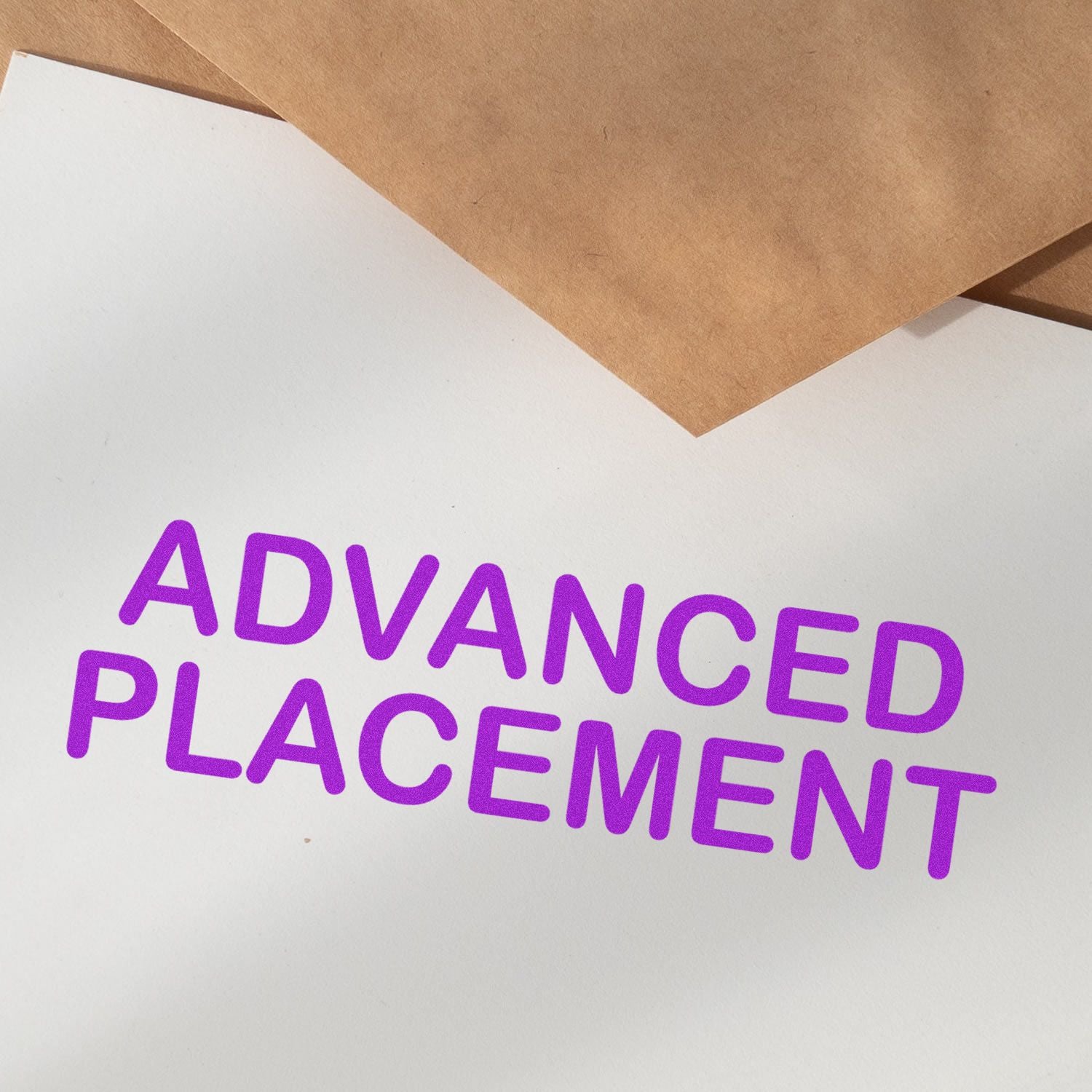 Purple 'Advanced Placement' rubber stamp imprint on white paper with brown envelopes in the background.