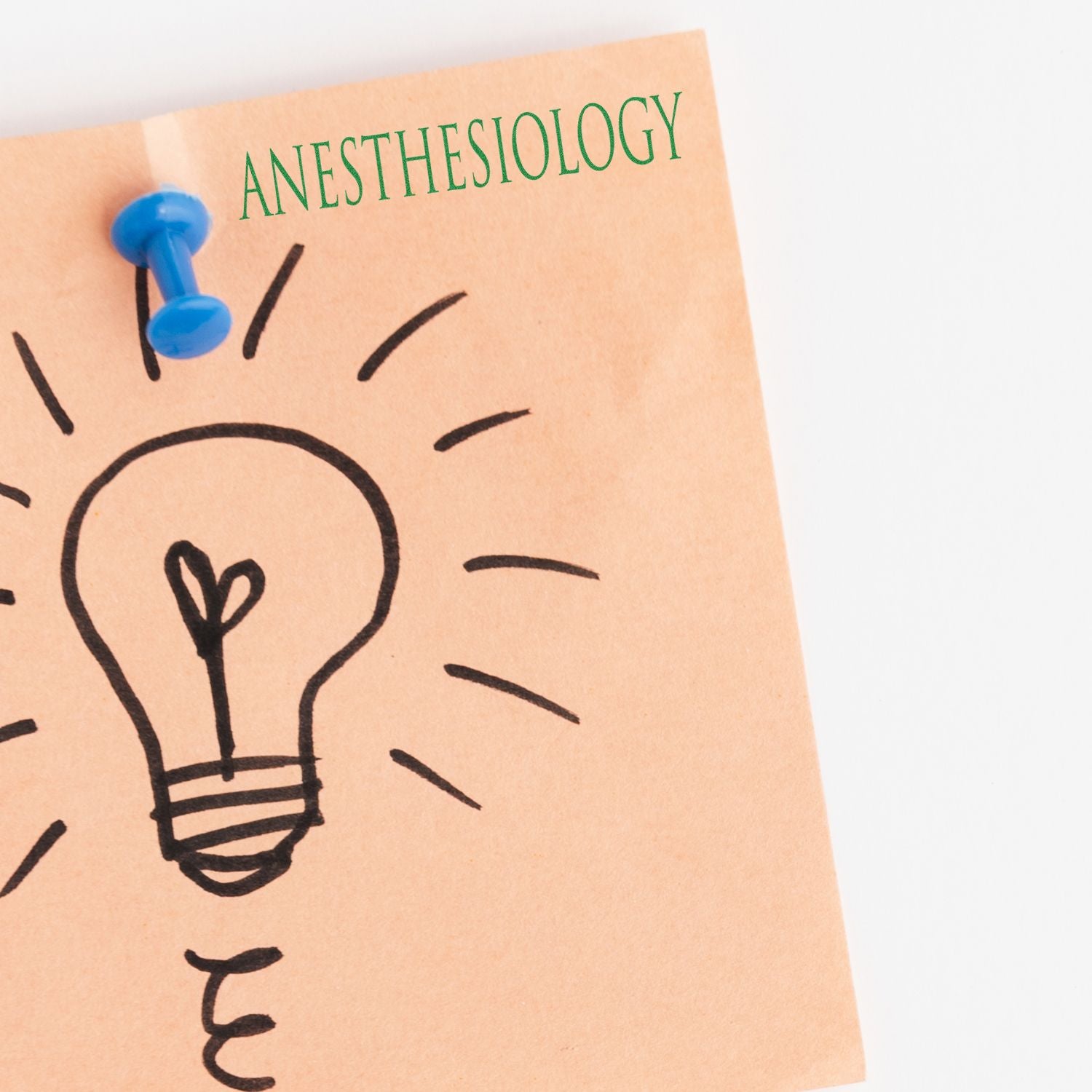 A Large Self Inking Anesthesiology Stamp marks a sticky note with a lightbulb drawing, pinned with a blue pushpin.