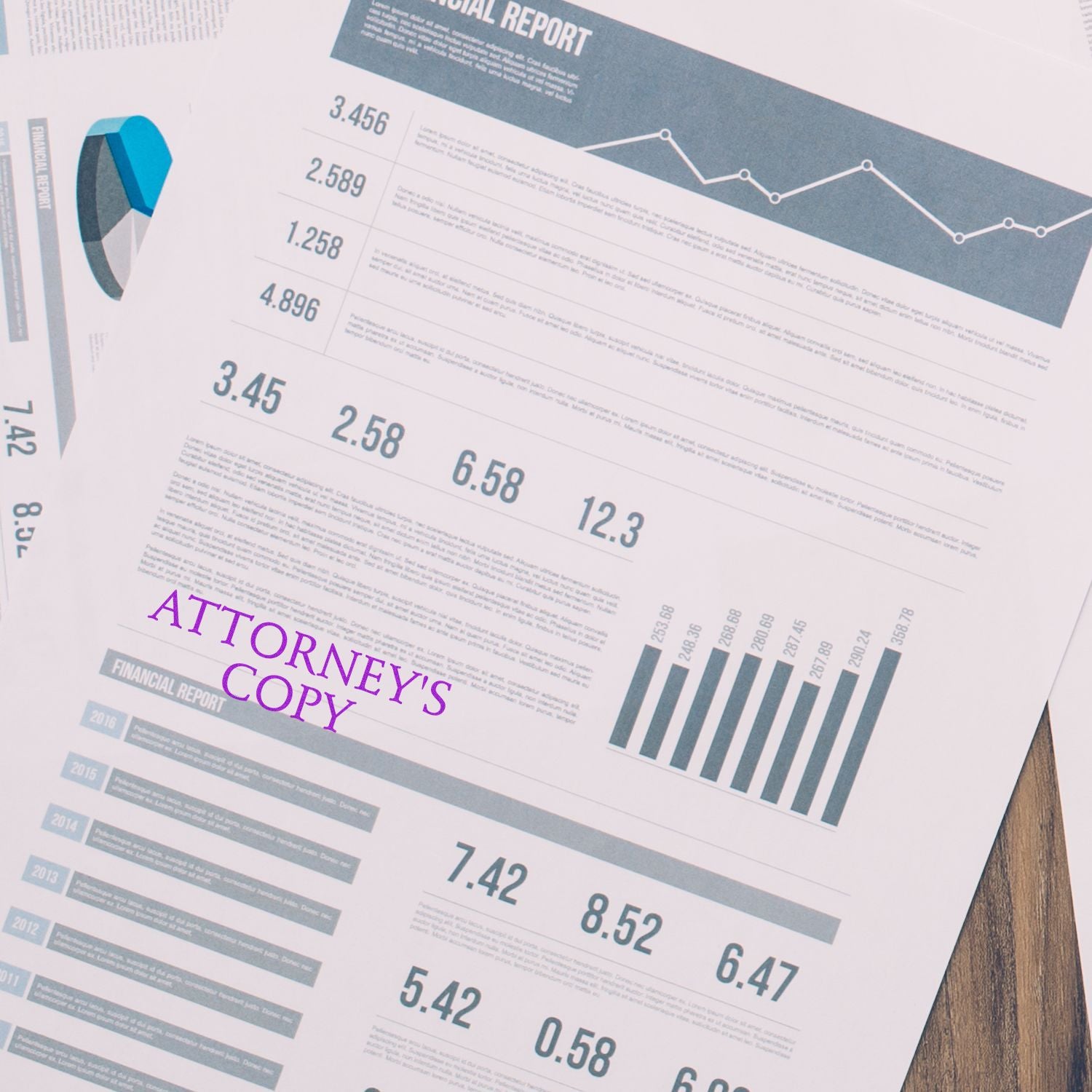 A financial report stamped with ATTORNEY'S COPY using the Large Attorneys Copy Rubber Stamp, placed on a wooden desk.