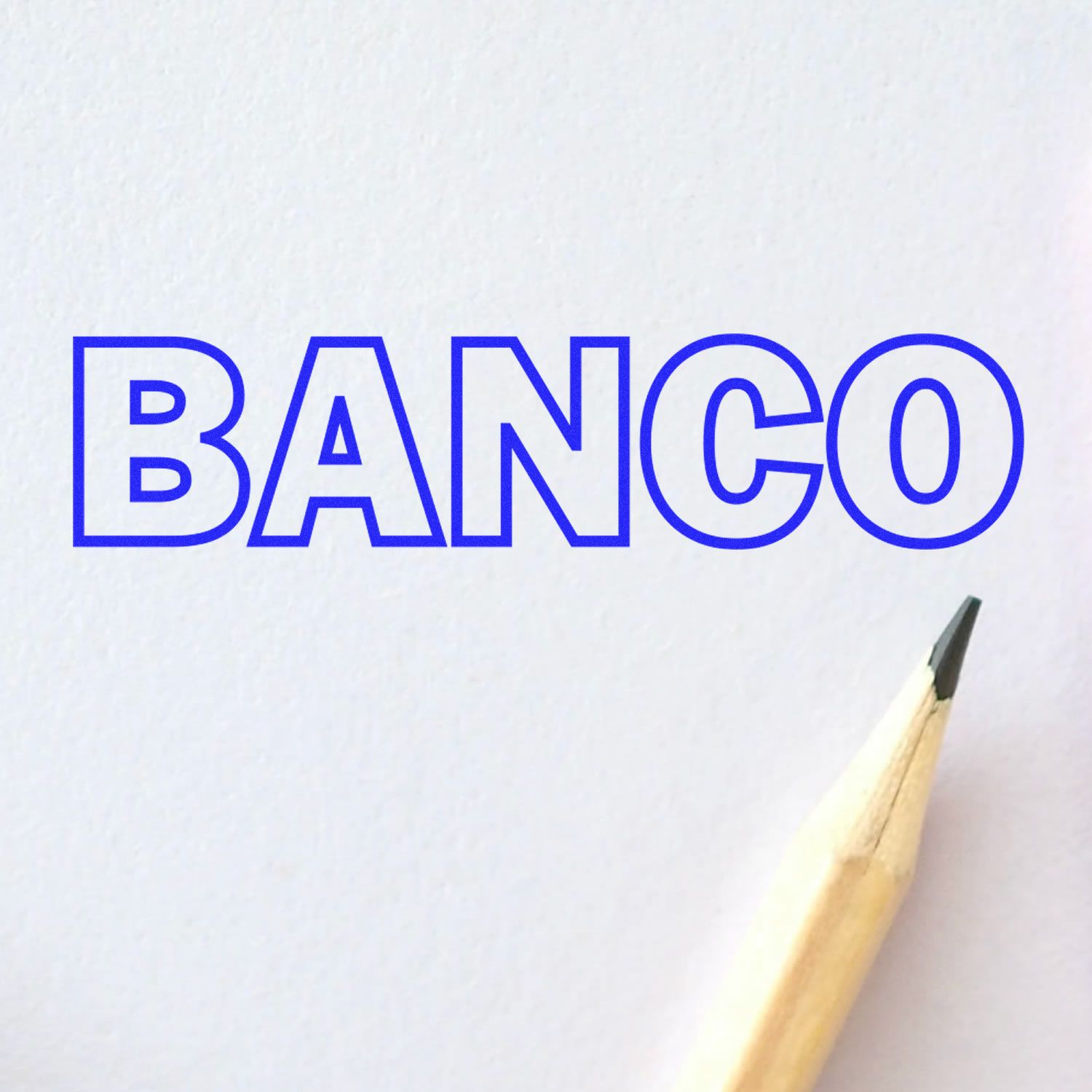 Large Pre-Inked Banco Stamp imprint in blue ink on white paper, with a sharpened pencil tip visible in the bottom right corner.