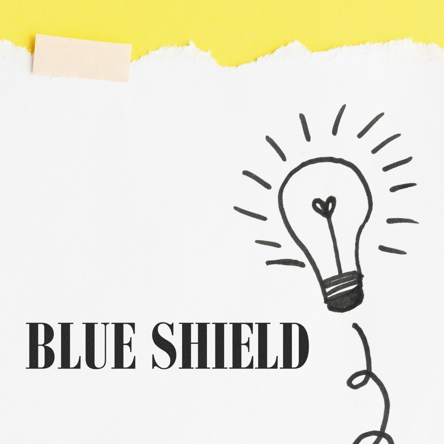 Blue Shield Rubber Stamp on white paper with a light bulb drawing, set against a yellow background.