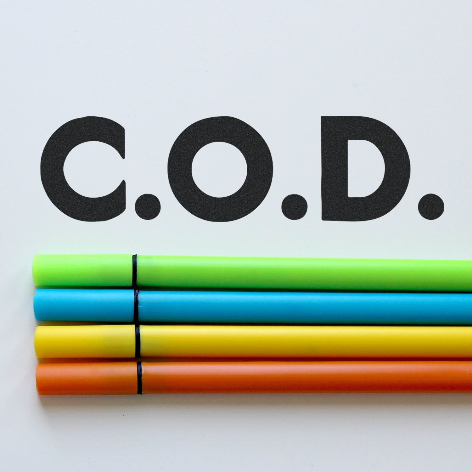 Large Self Inking Bold C.O.D. Stamp in use, displaying C.O.D. in bold black letters on a white background with colorful markers below.