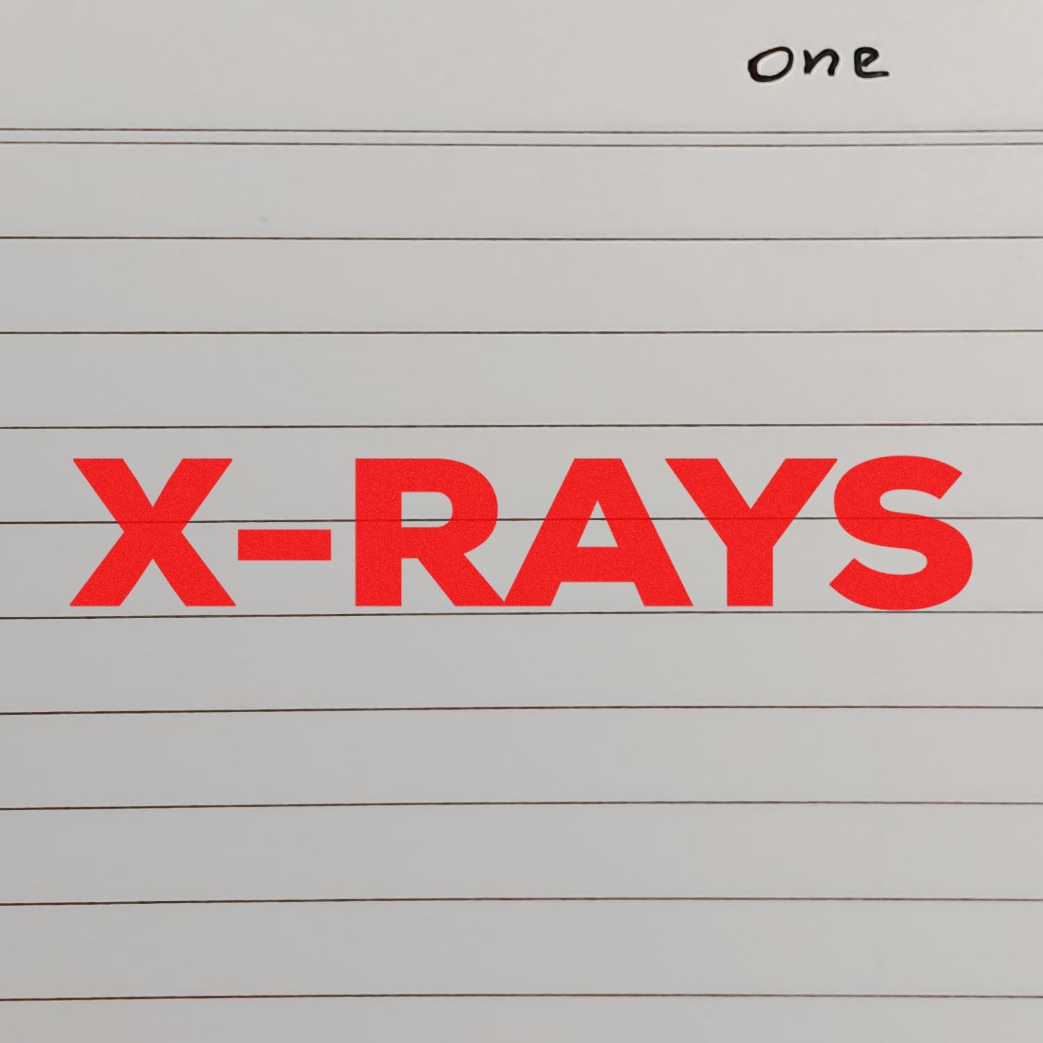 Self Inking Bold X-Rays Stamp in use, displaying a bright red X-RAYS imprint on lined paper.