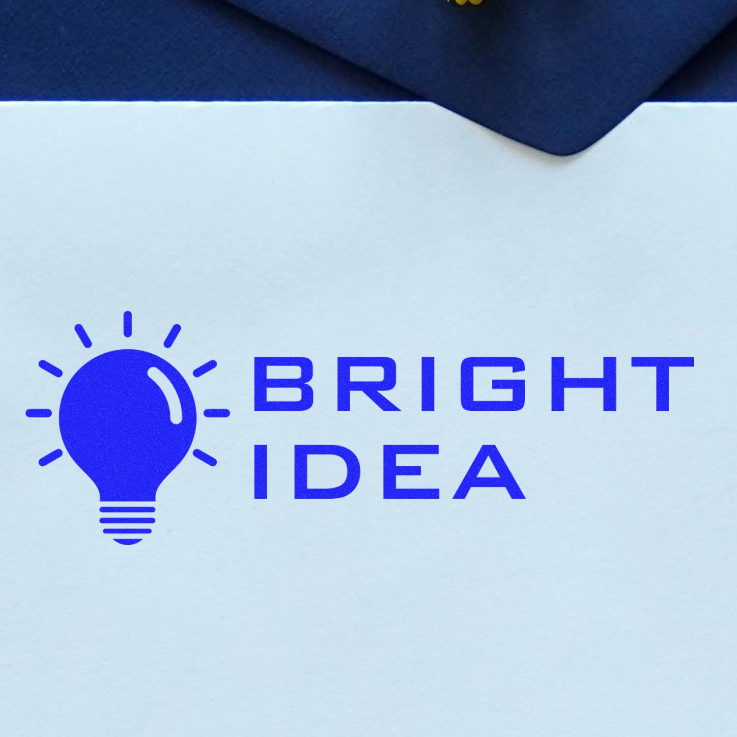 Large Self Inking Bright Idea Stamp in use, displaying a blue light bulb icon with the text 'Bright Idea' on a white surface.