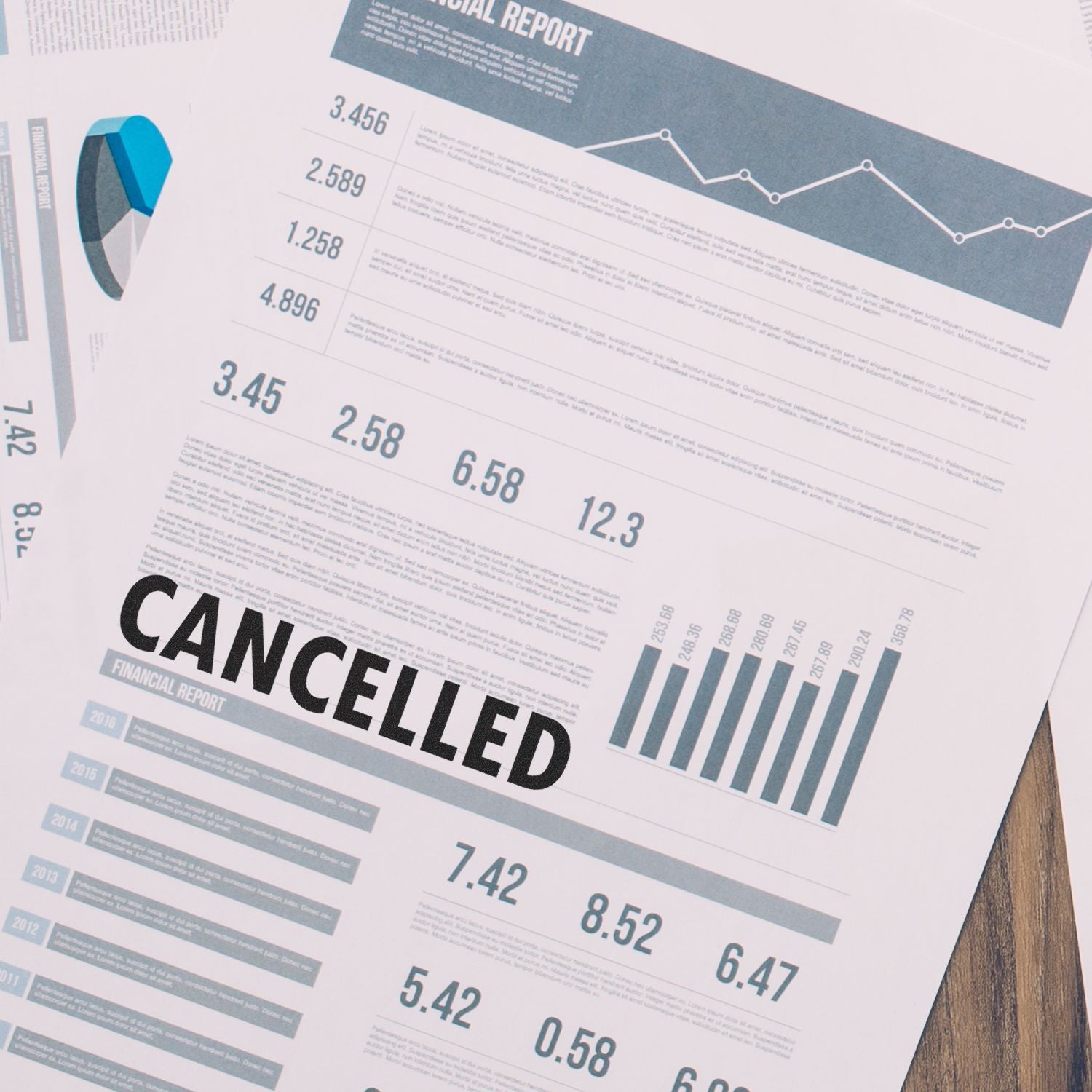 Financial report stamped with CANCELLED using the Large Cancelled Rubber Stamp, showing graphs and data on a wooden surface.