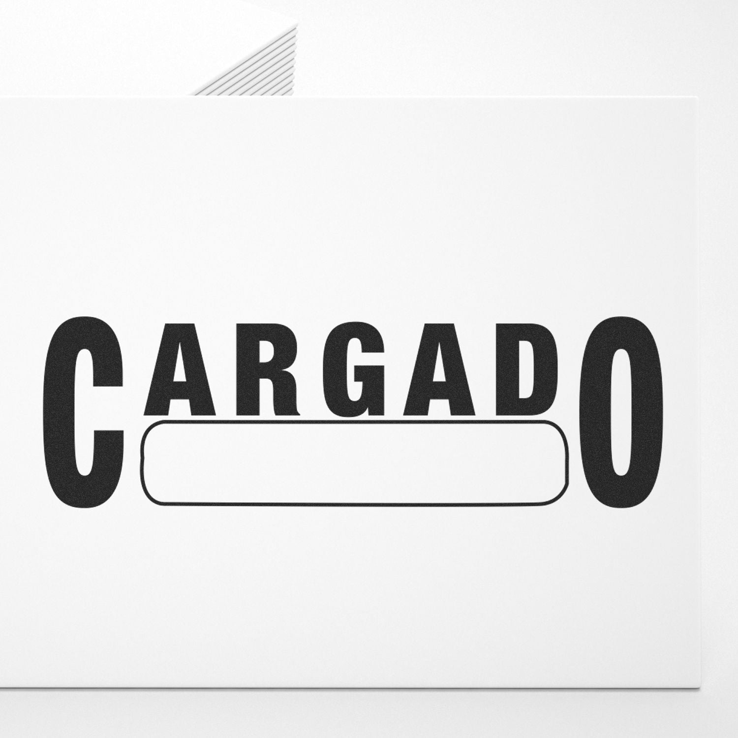 Self Inking Cargado Stamp imprinting the word Cargado in bold black letters on a white sheet of paper.