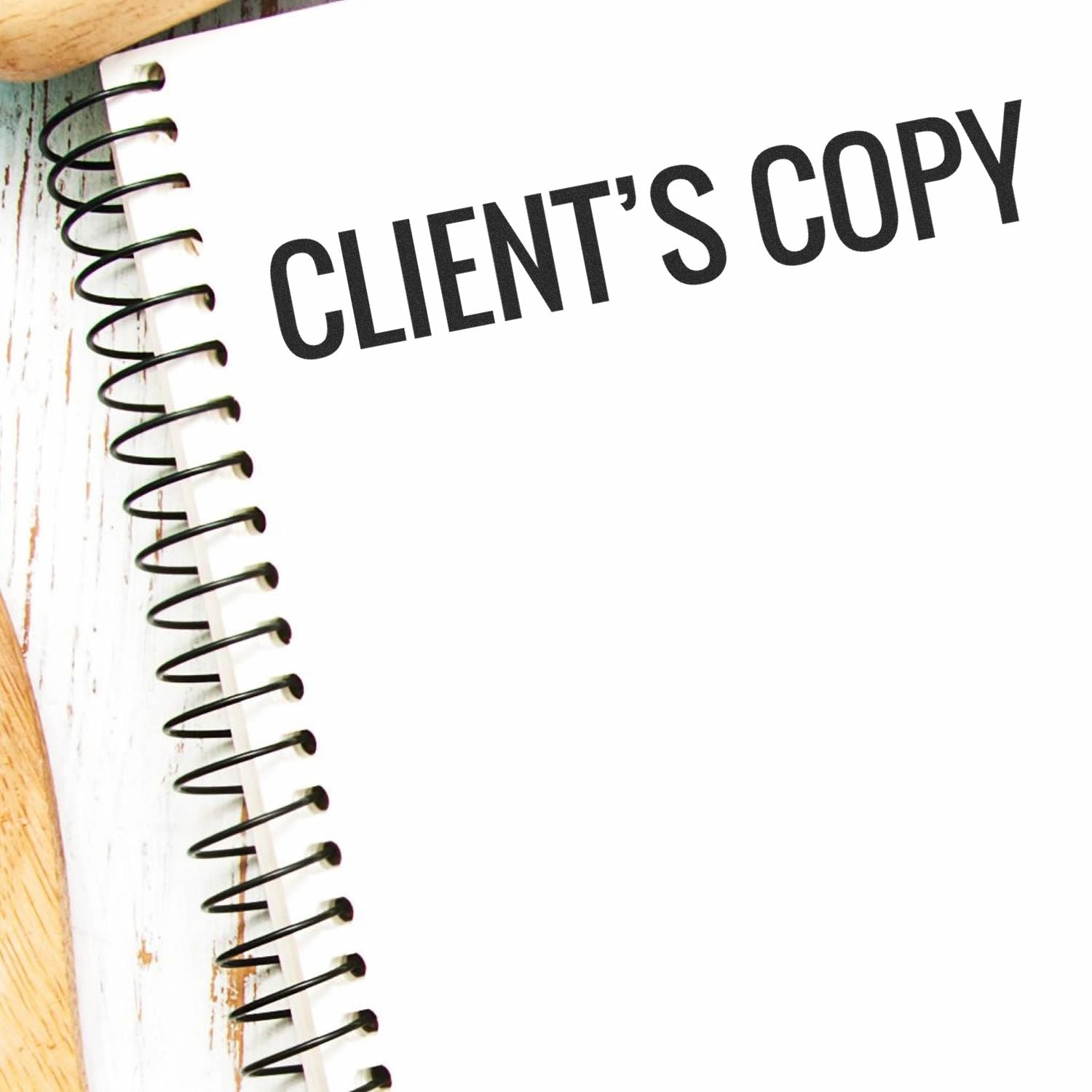 Large Pre-Inked Client's Copy Stamp used on a spiral notebook, displaying the text CLIENT'S COPY in bold black letters.