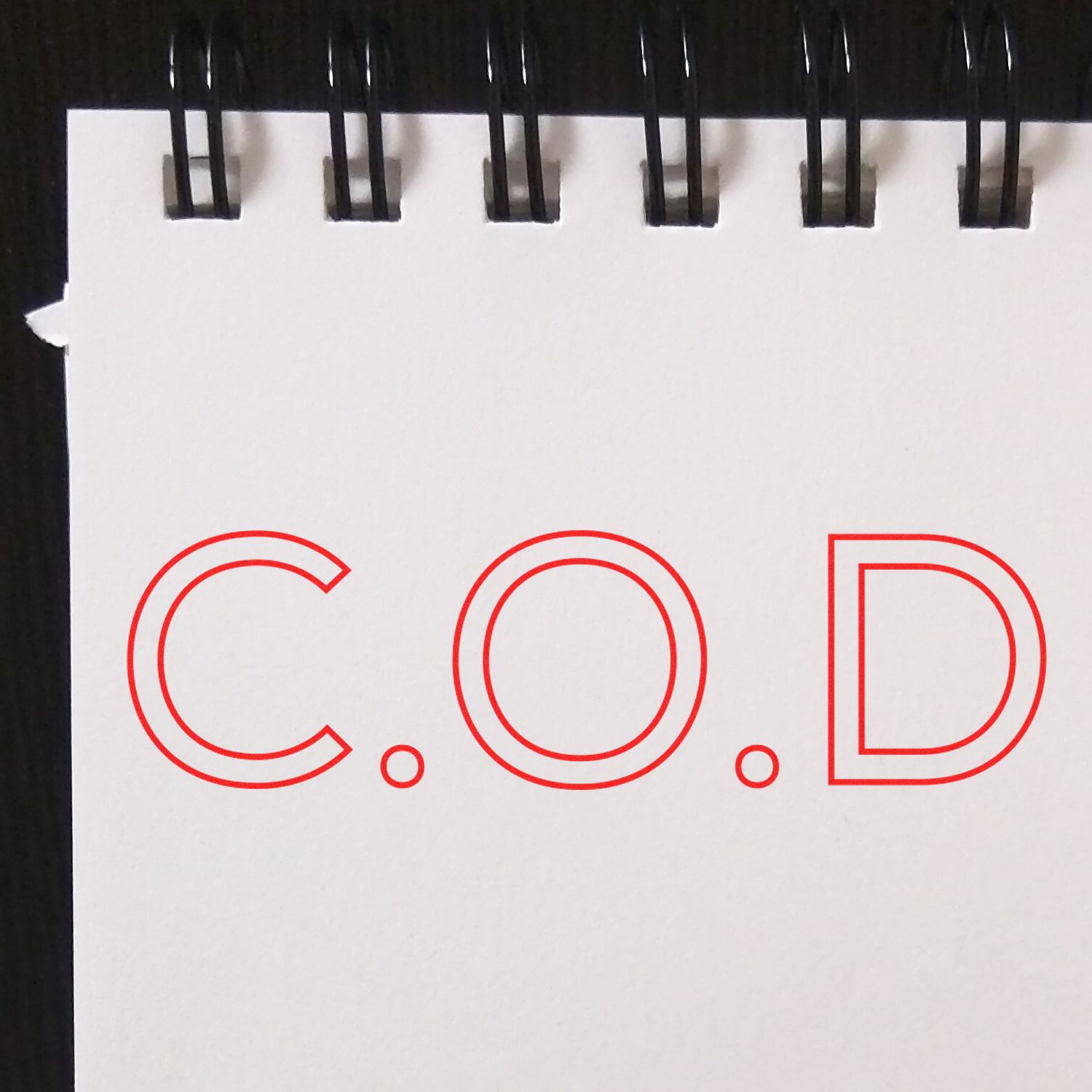 Large Pre-Inked COD Outline Stamp in use on white paper, showing clear, bold red C.O.D text.