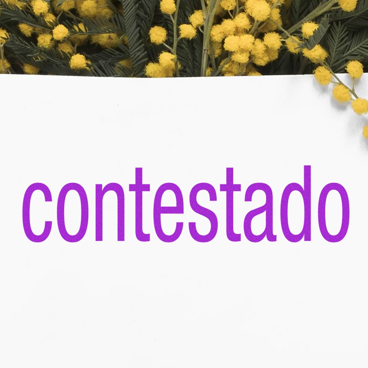 Contestado Rubber Stamp in use, displaying the word 'contestado' in purple ink on white paper, with yellow flowers in the background.