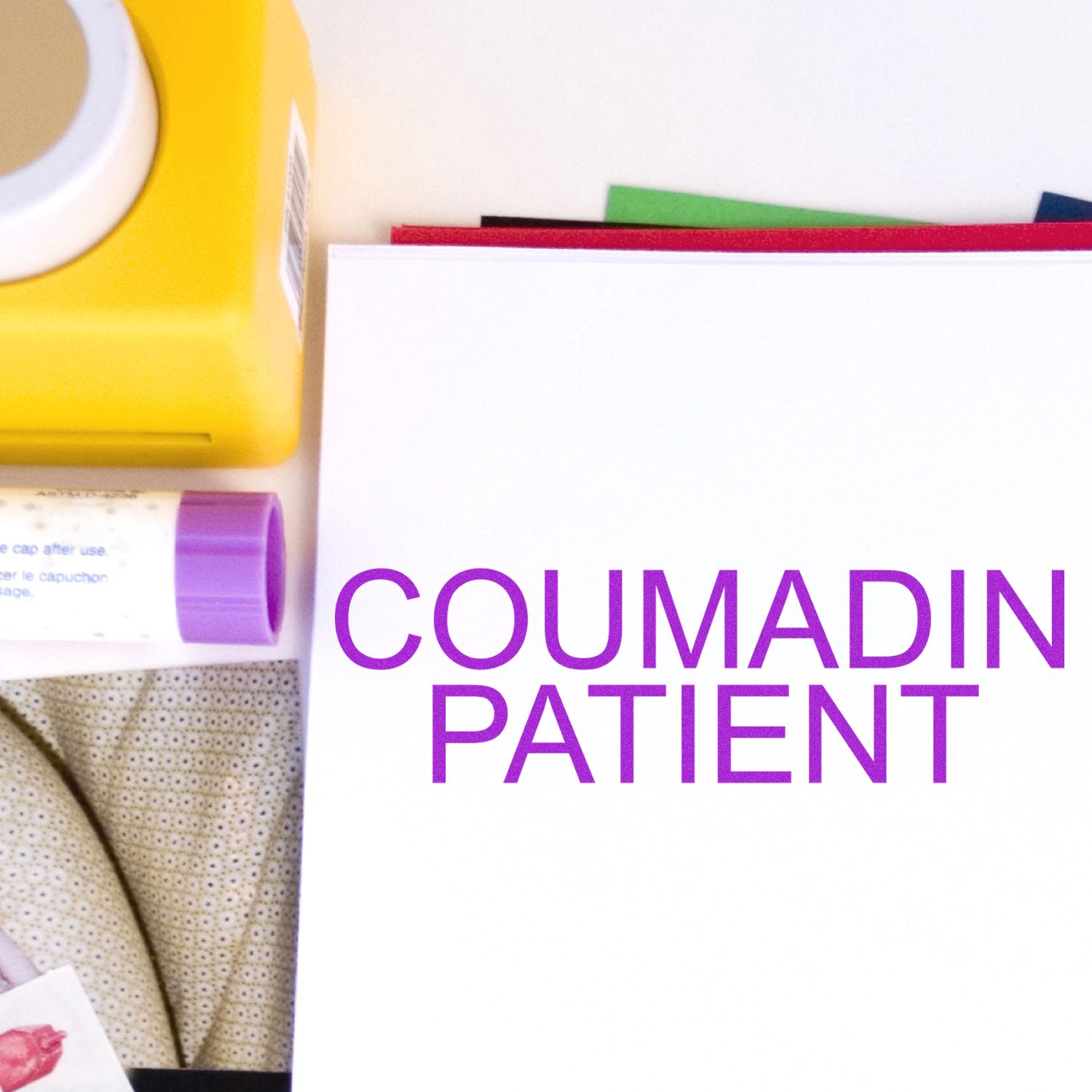 Large Coumadin Patient Rubber Stamp in use, stamping COUMADIN PATIENT in purple ink on white paper, with stamp and ink pad visible.