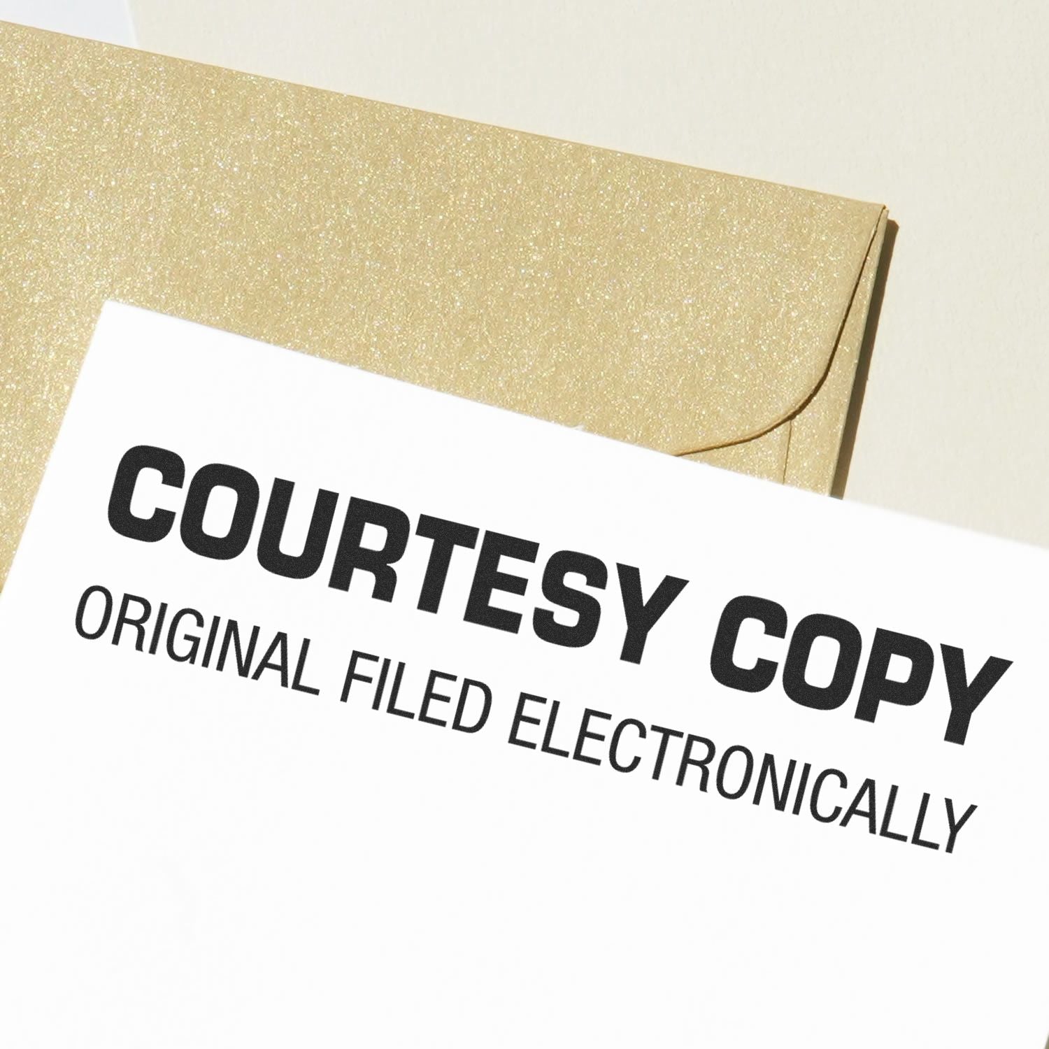 Large Self Inking Courtesy Copy Original Filed Electronically Stamp used on a white document, with a gold envelope in the background.