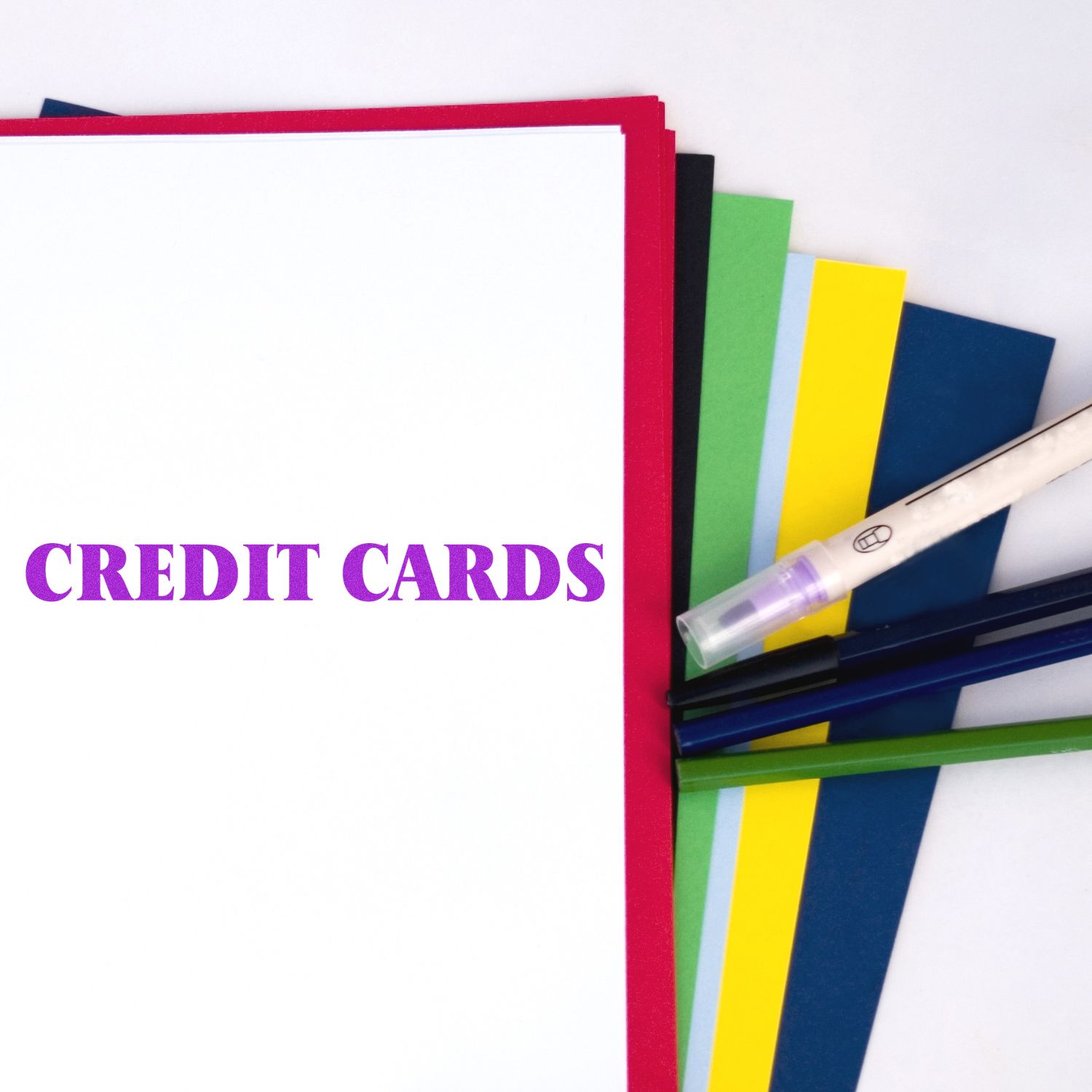 Credit Cards Rubber Stamp used on white paper, surrounded by colorful sheets and pens.