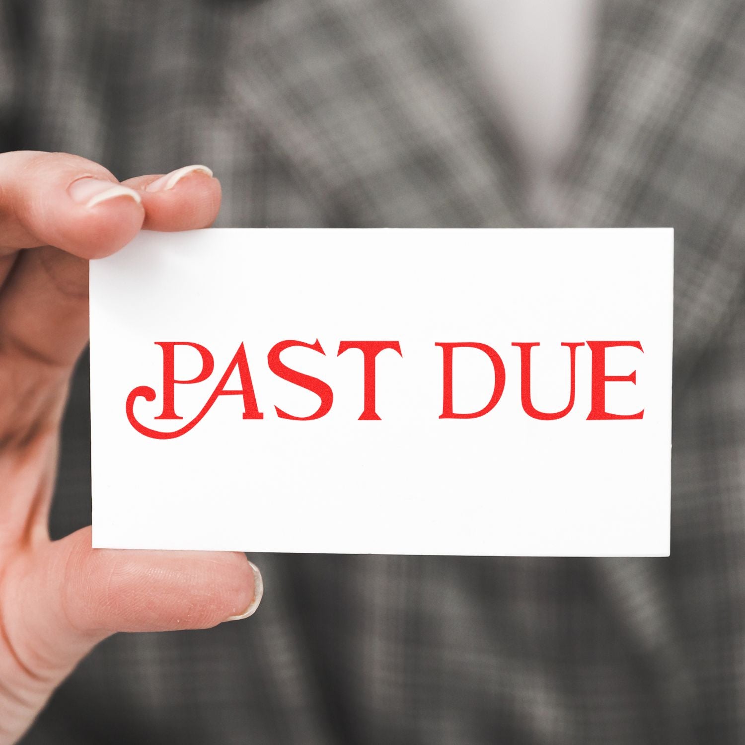 Hand holding a card stamped with PAST DUE in red using the Large Self Inking Curley Past Due Stamp, person wearing a plaid jacket.