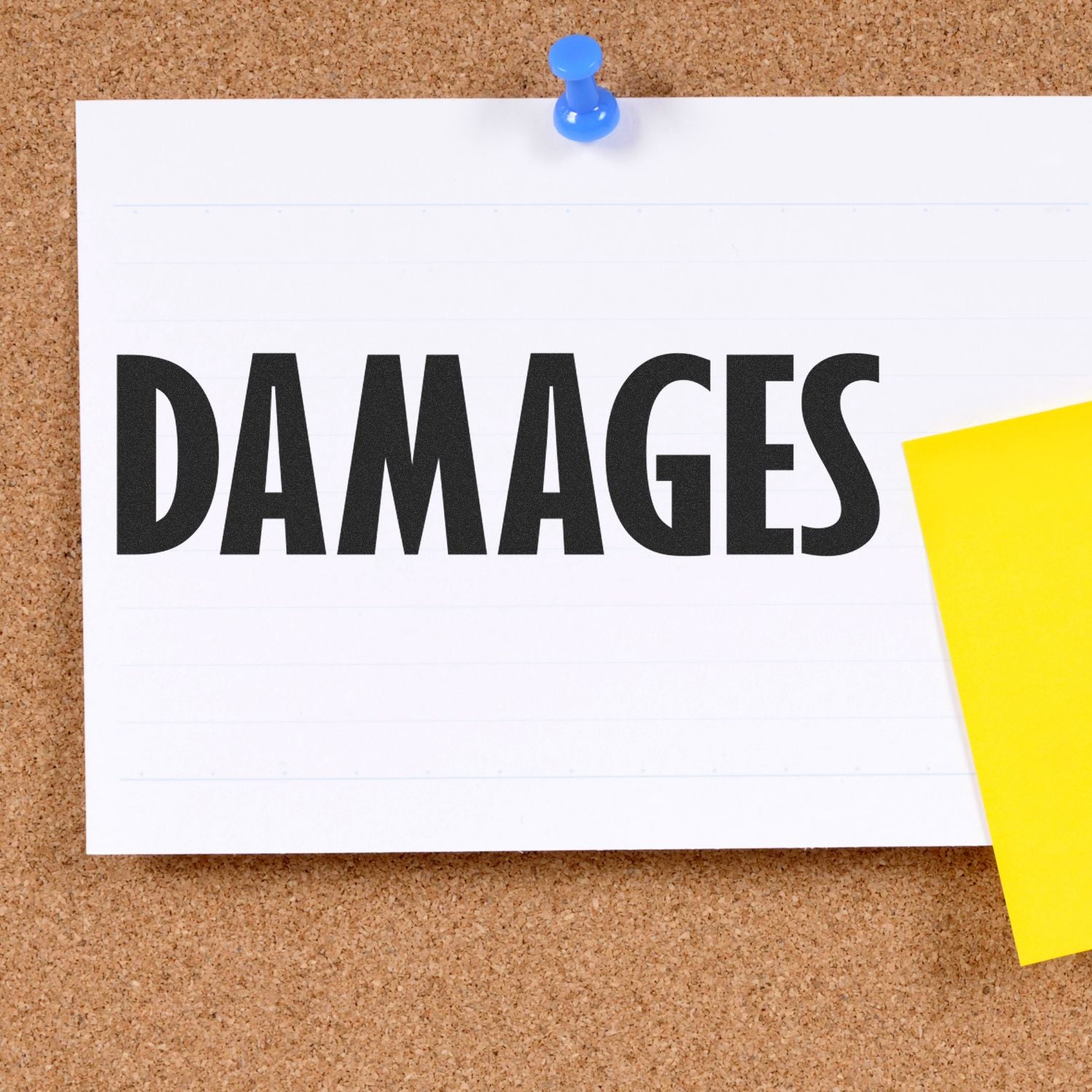 A corkboard with a pinned note stamped DAMAGES using the Large Damages Rubber Stamp, next to a yellow sticky note.