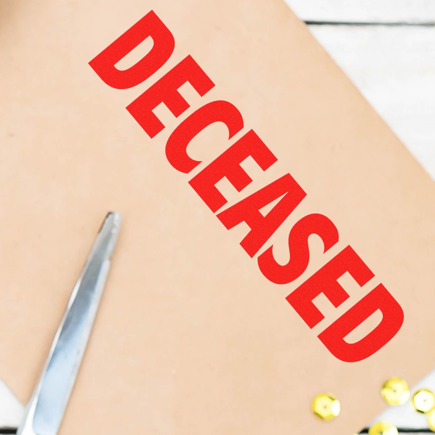 Envelope stamped with DECEASED in red using the Self Inking Deceased Stamp, next to a pair of scissors and gold push pins.