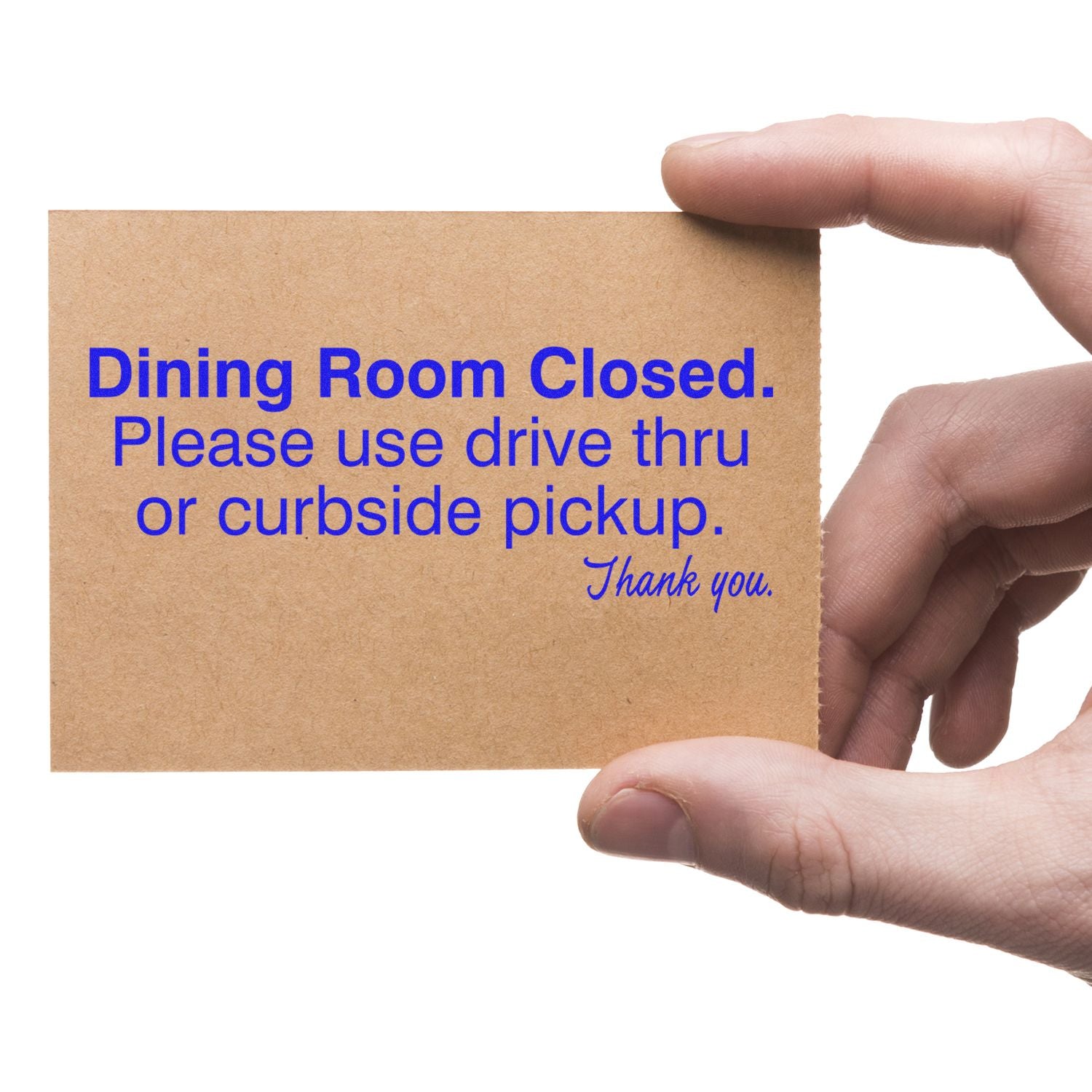 A hand holding a card stamped with Dining Room Closed. Please use drive thru or curbside pickup. Thank you. using the Dining Room Closed Rubber Stamp.