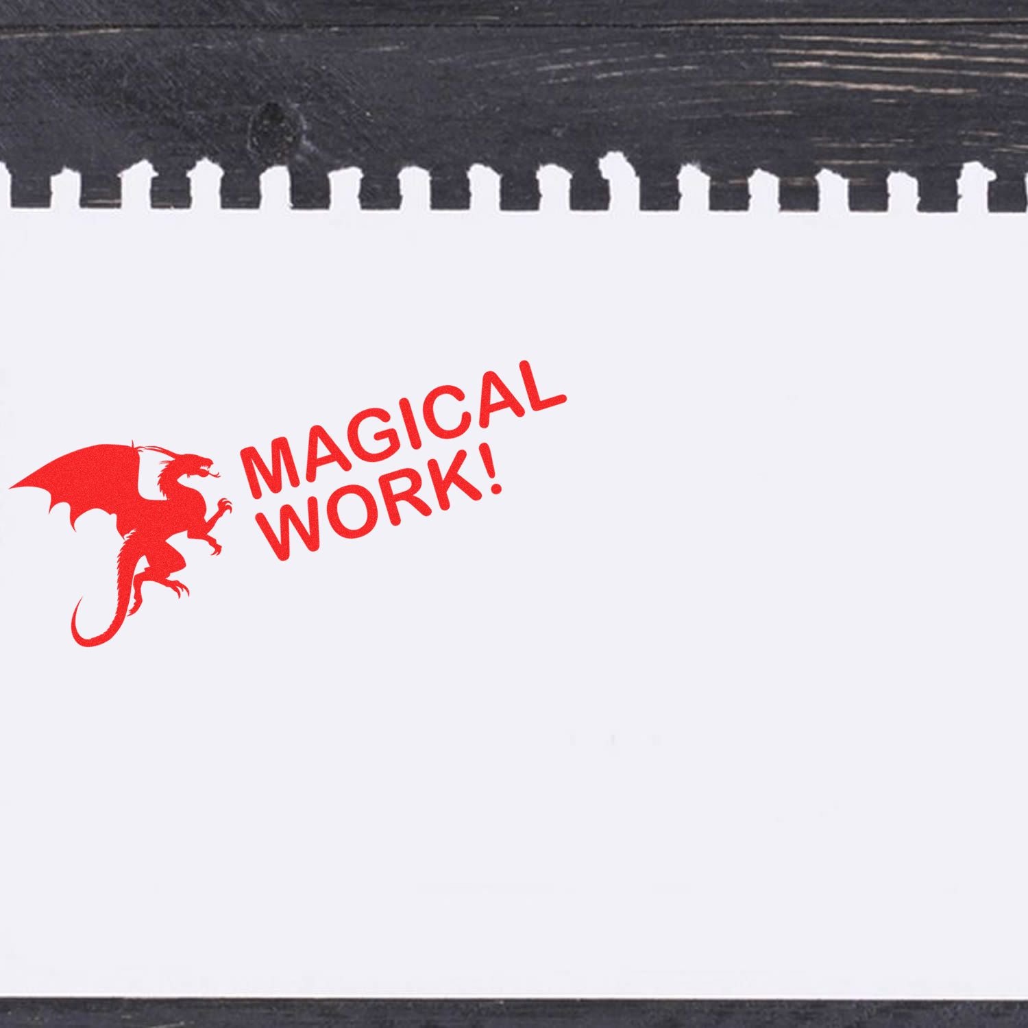 A red dragon and MAGICAL WORK! stamped on white paper using the Large Dragon Magical Work Rubber Stamp, placed on a dark wooden surface.