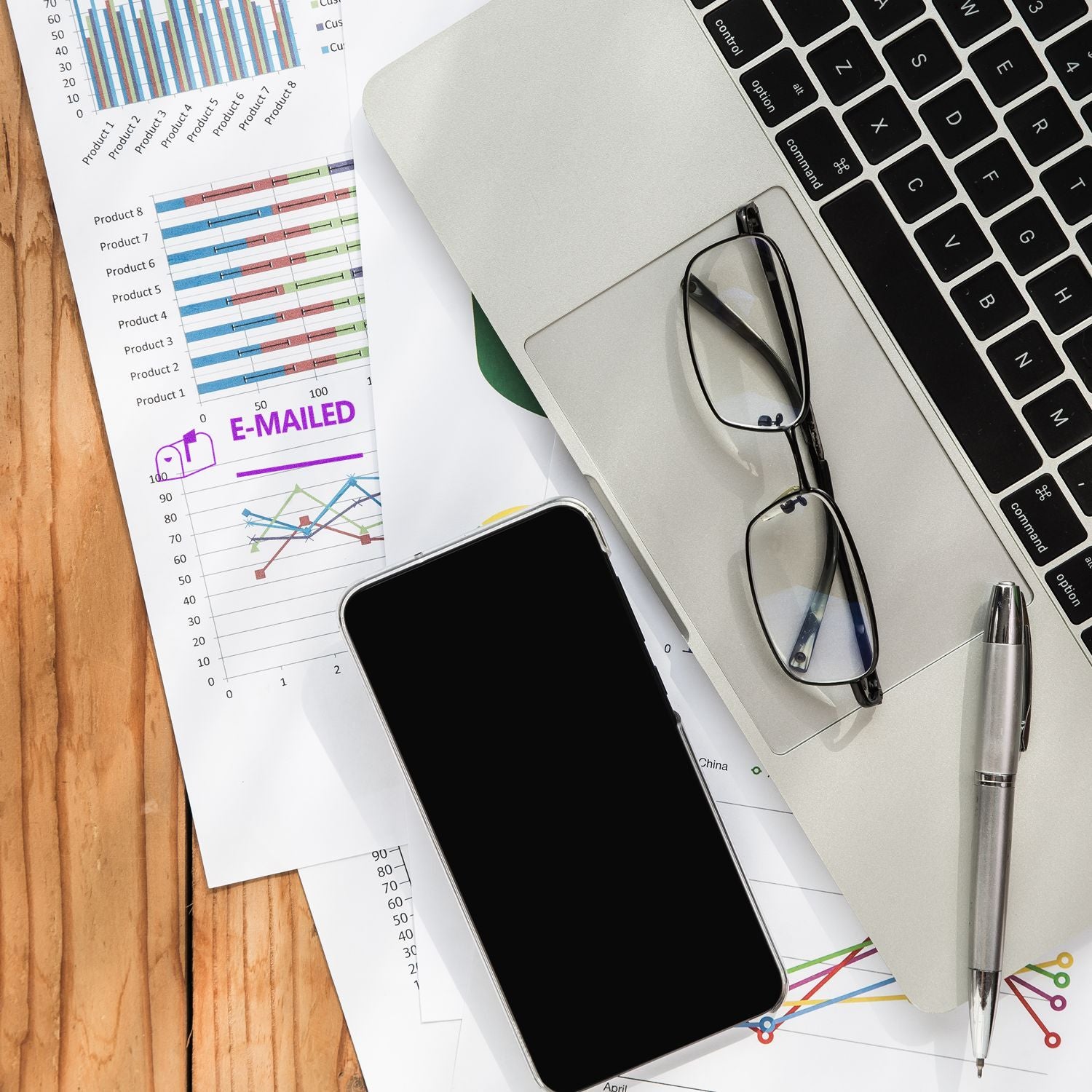 Large Self Inking Emailed with Mailbox Stamp on a desk with charts, a laptop, glasses, a smartphone, and a pen.