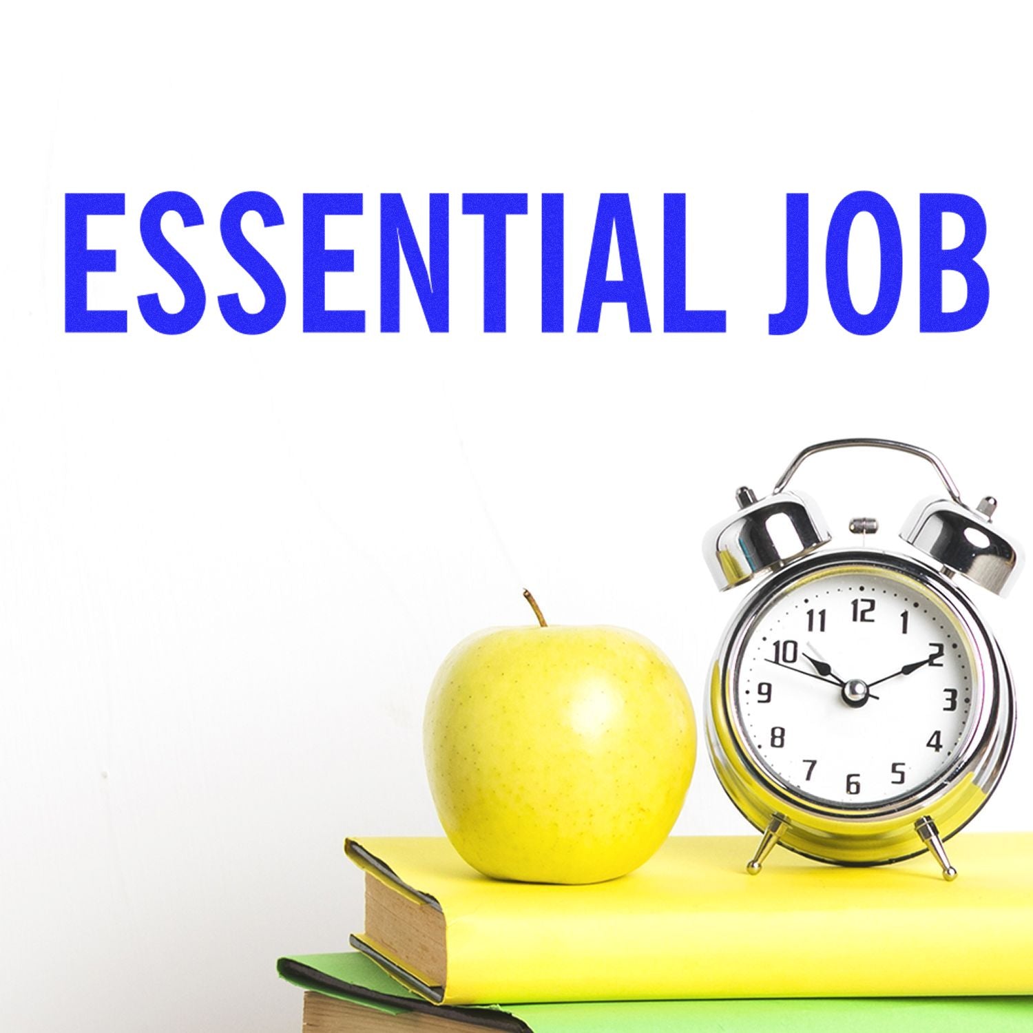 Large Essential Job Rubber Stamp used on a white background with an apple, clock, and books in the foreground.