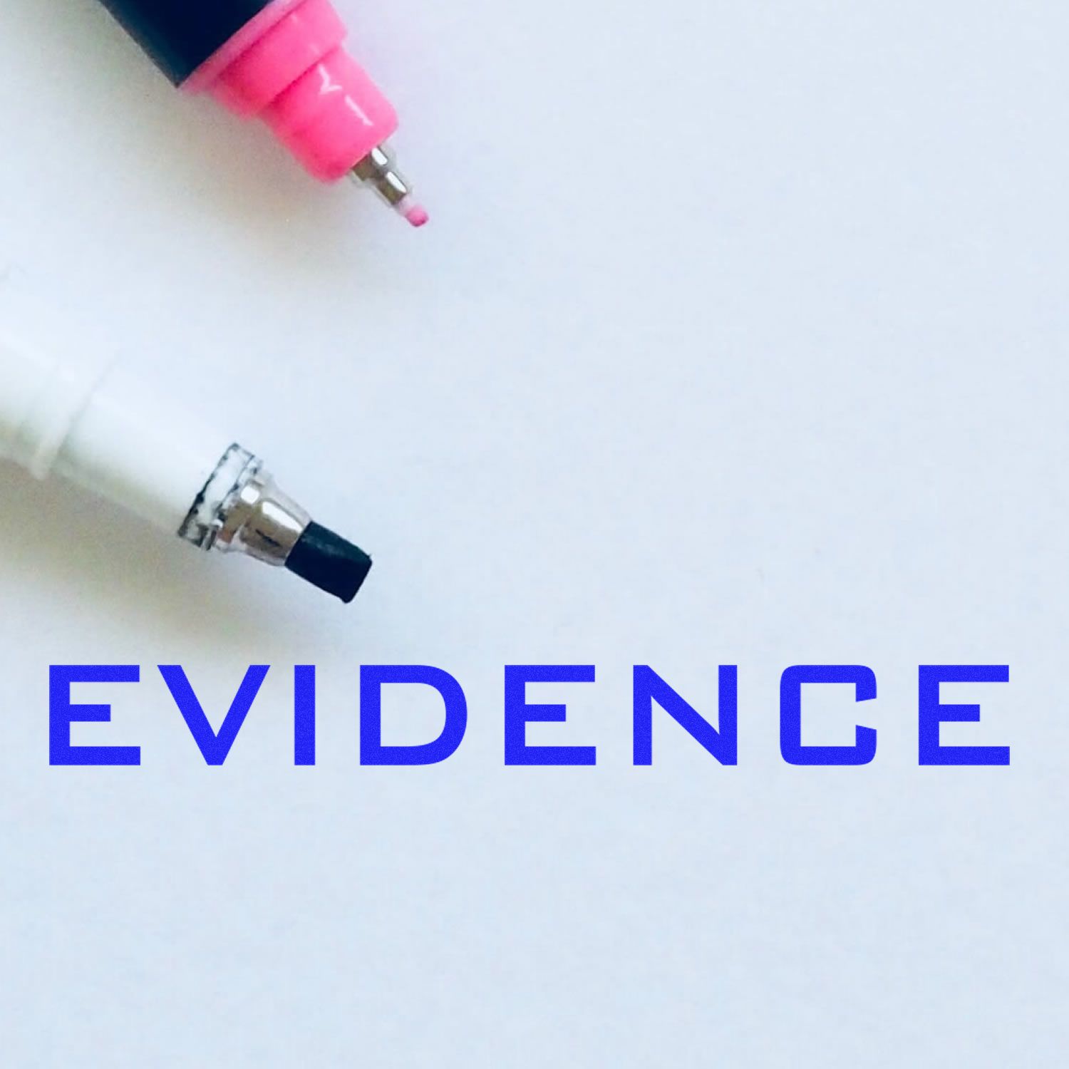 Evidence Rubber Stamp in blue ink on white paper, with pink and black markers nearby.