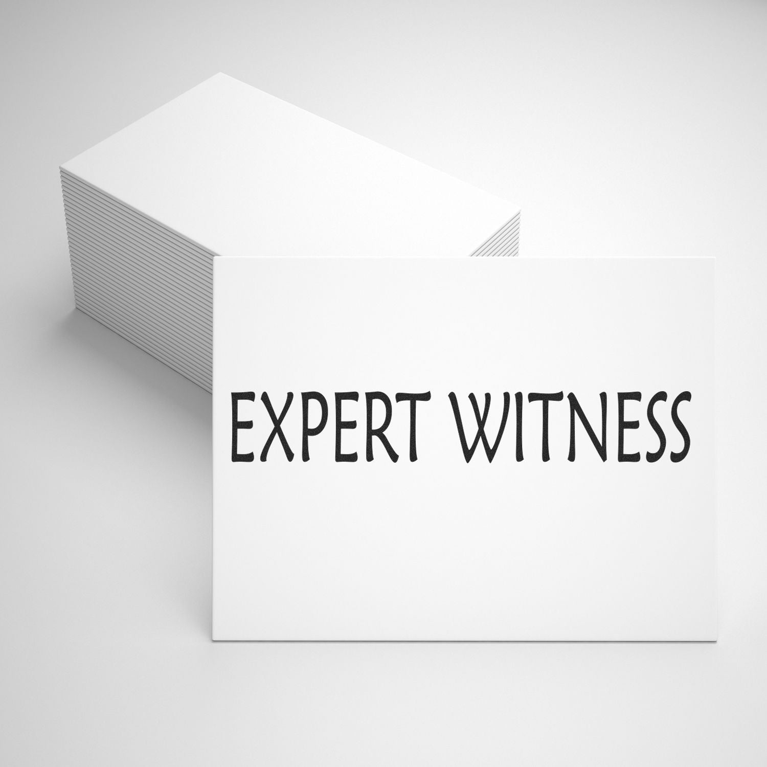 A stack of white cards stamped with EXPERT WITNESS using the Expert Witness Rubber Stamp, displayed on a plain background.