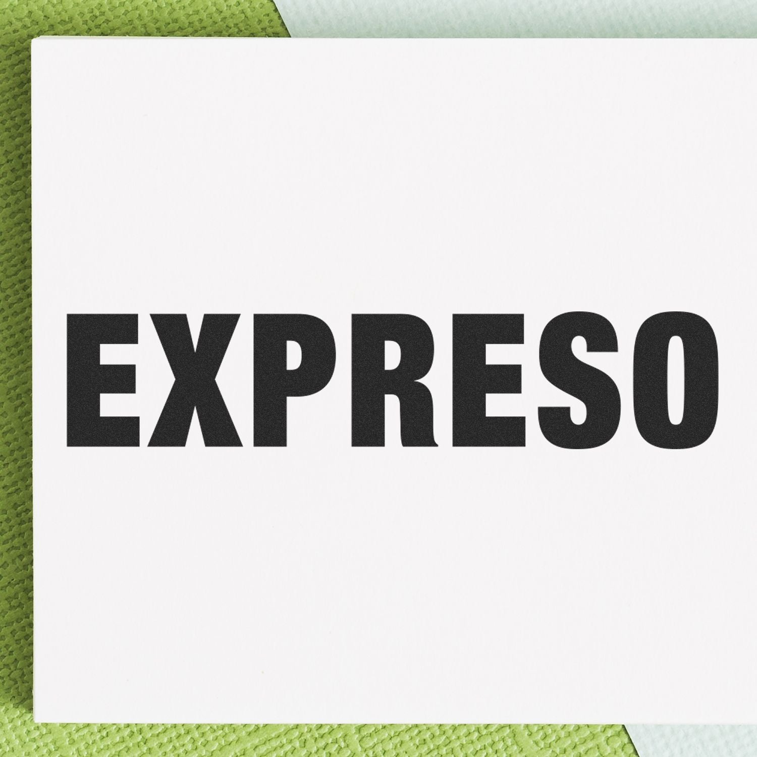 Expreso Rubber Stamp in use, displaying the word EXPRESO in bold black letters on a white background with a green textured surface.