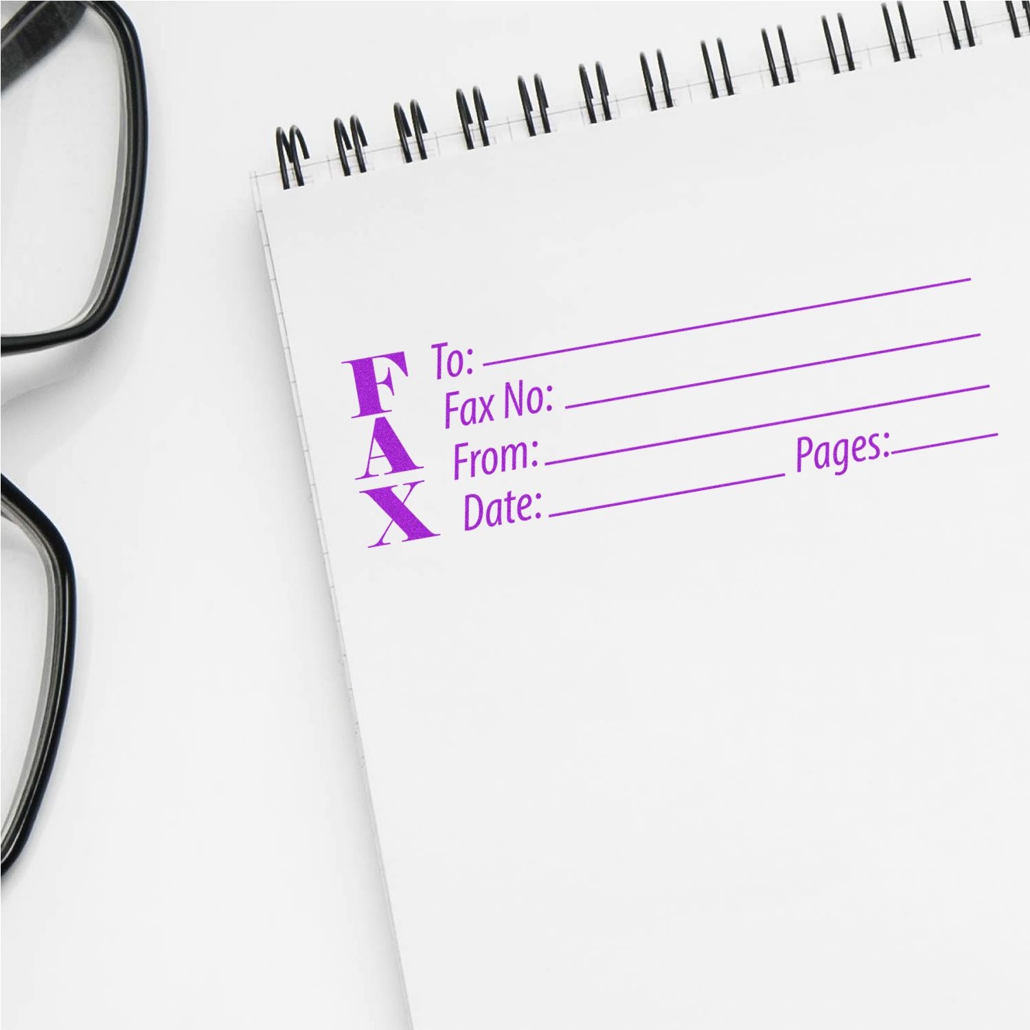 Large Fax Rubber Stamp in use on a white notepad with glasses nearby, showing fields for To, Fax No, From, Date, and Pages in purple ink.