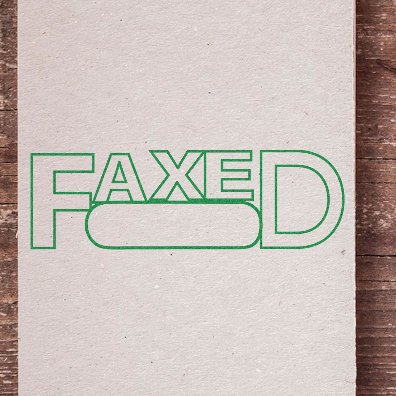 Slim Pre-Inked Faxed with Round Date Box Stamp in green ink on white paper, placed on a wooden surface.