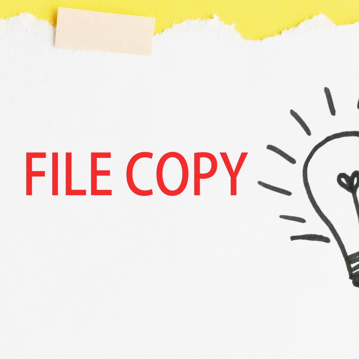 Slim Pre-Inked File Copy Stamp marking FILE COPY in red on a white paper with a lightbulb drawing, against a yellow background.