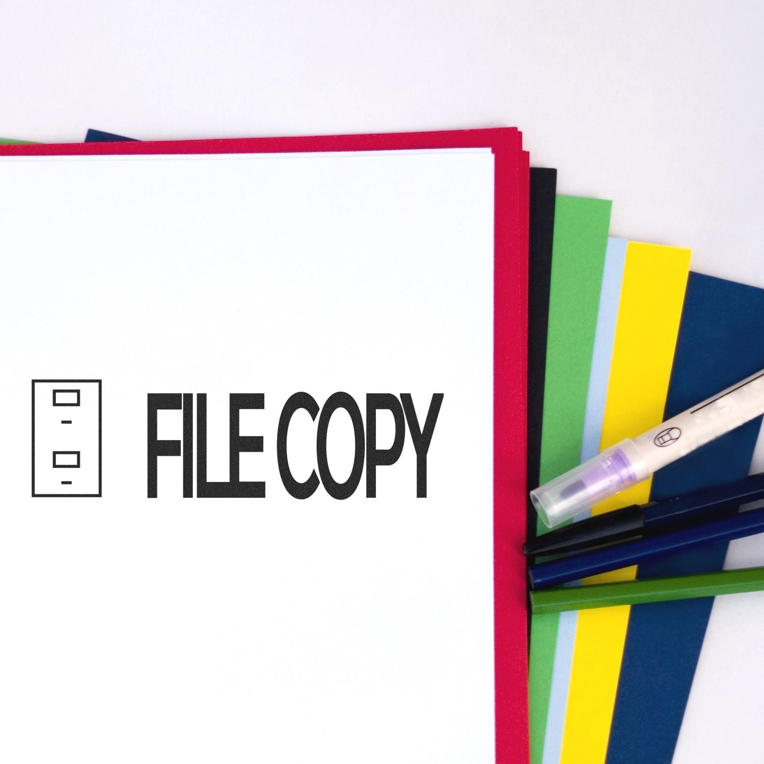 Large File Copy with Drawer Rubber Stamp used on a white sheet, surrounded by colorful folders and pens.