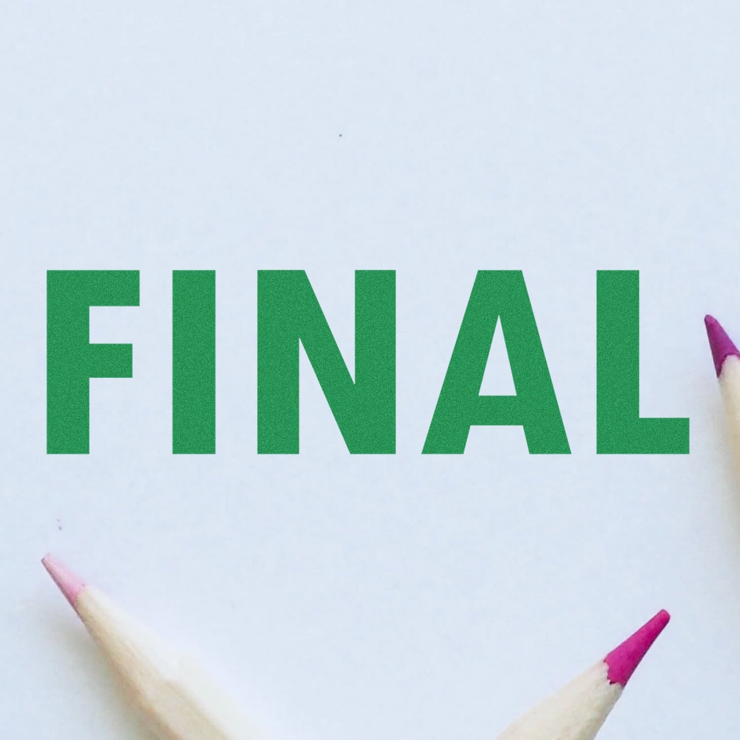 Large Final Rubber Stamp imprint in green ink on white paper, surrounded by pencils with pink erasers.