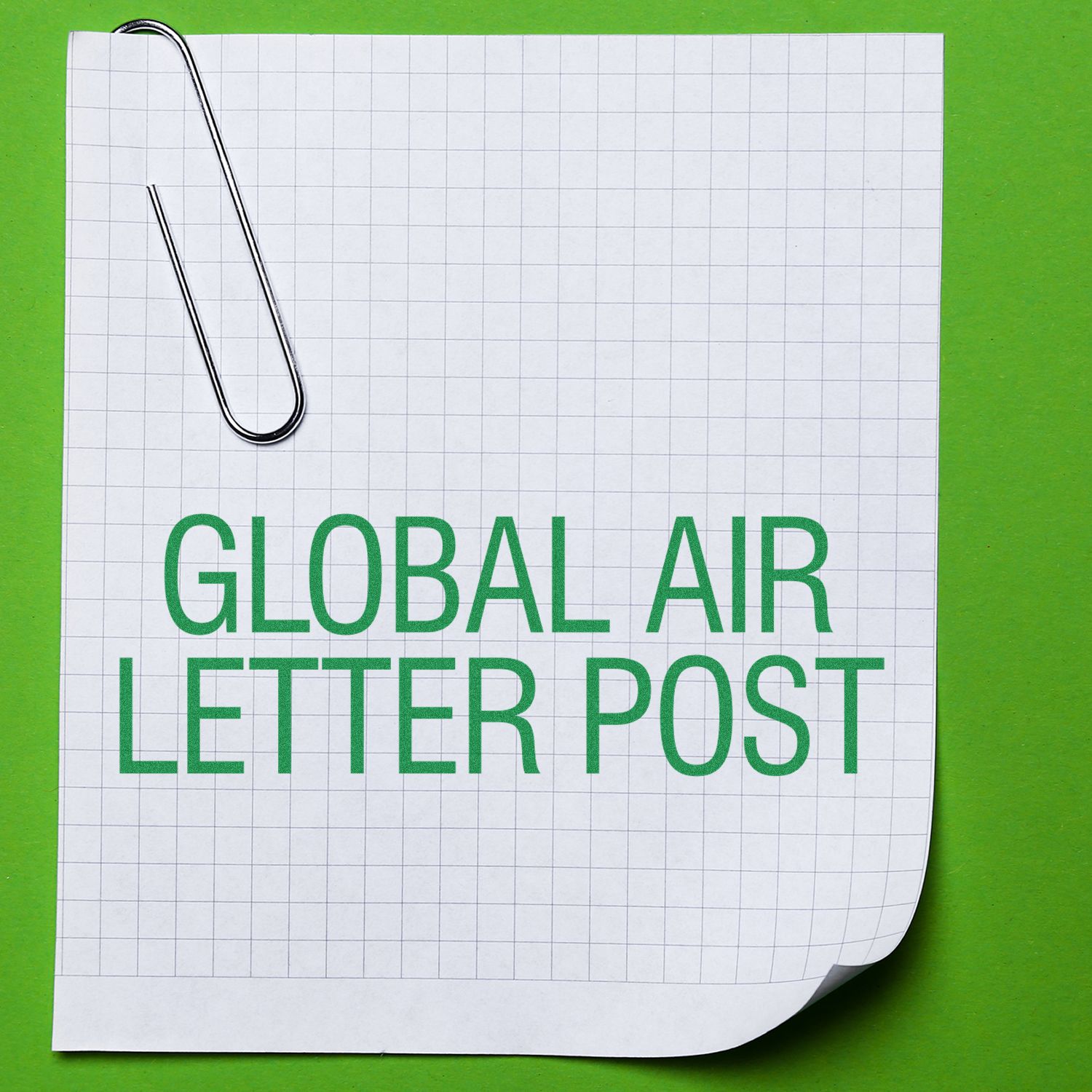 A paper with a grid pattern and a paperclip, stamped with Global Air Letter Post Rubber Stamp in green, on a green background.