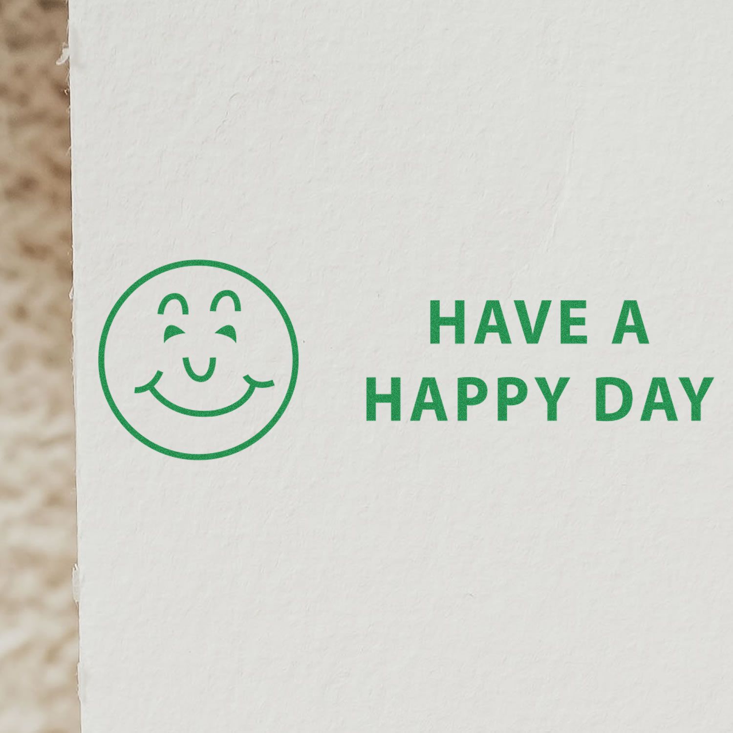 Large Have a Happy Day Rubber Stamp used on white paper, featuring a green smiling face and the text HAVE A HAPPY DAY in green.