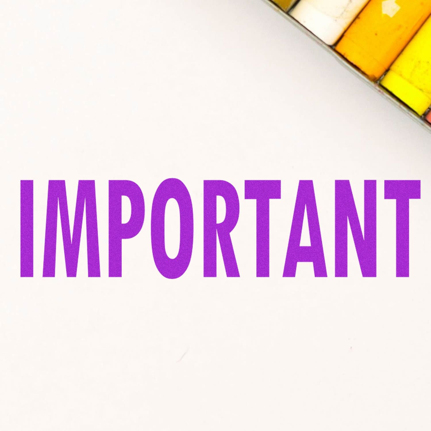 Important Rubber Stamp in use, displaying the word 'IMPORTANT' in bold purple letters on a white background with colored pencils nearby.