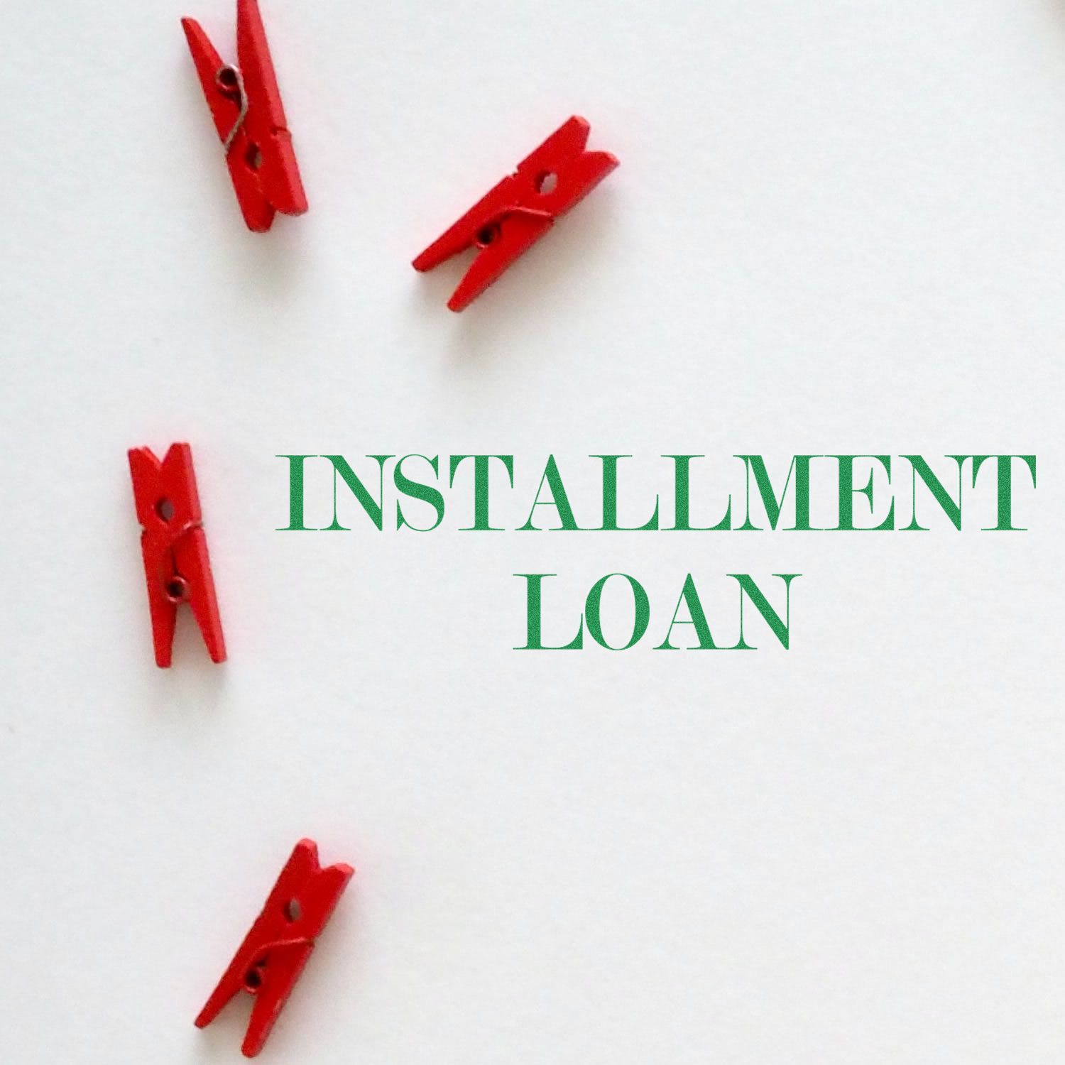 Red clothespins arranged around the text Installment Loan on a white background, showcasing the Installment Loan Rubber Stamp.