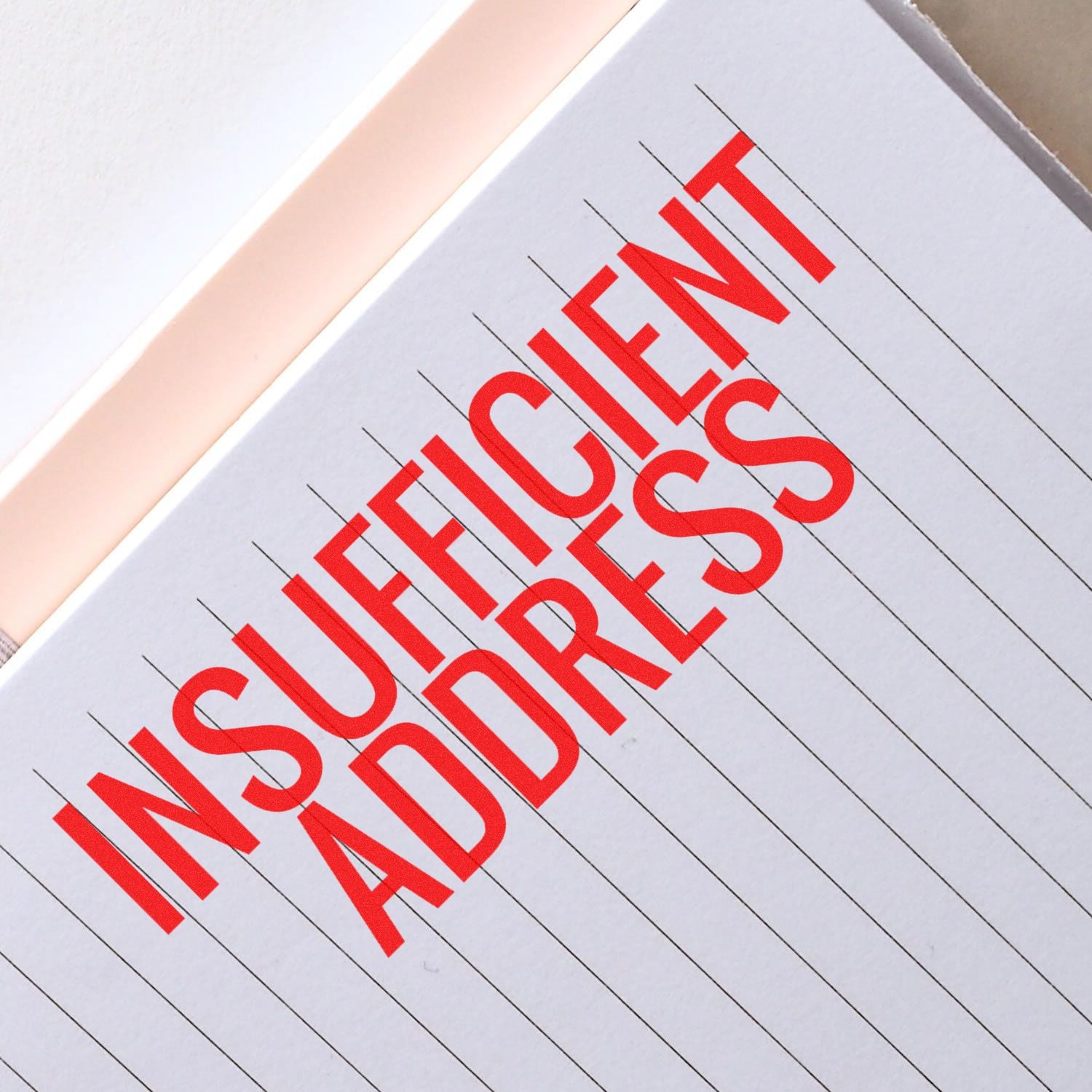 Large Self Inking Insufficient Address Stamp in red ink on a lined paper, highlighting the text INSUFFICIENT ADDRESS in bold letters.