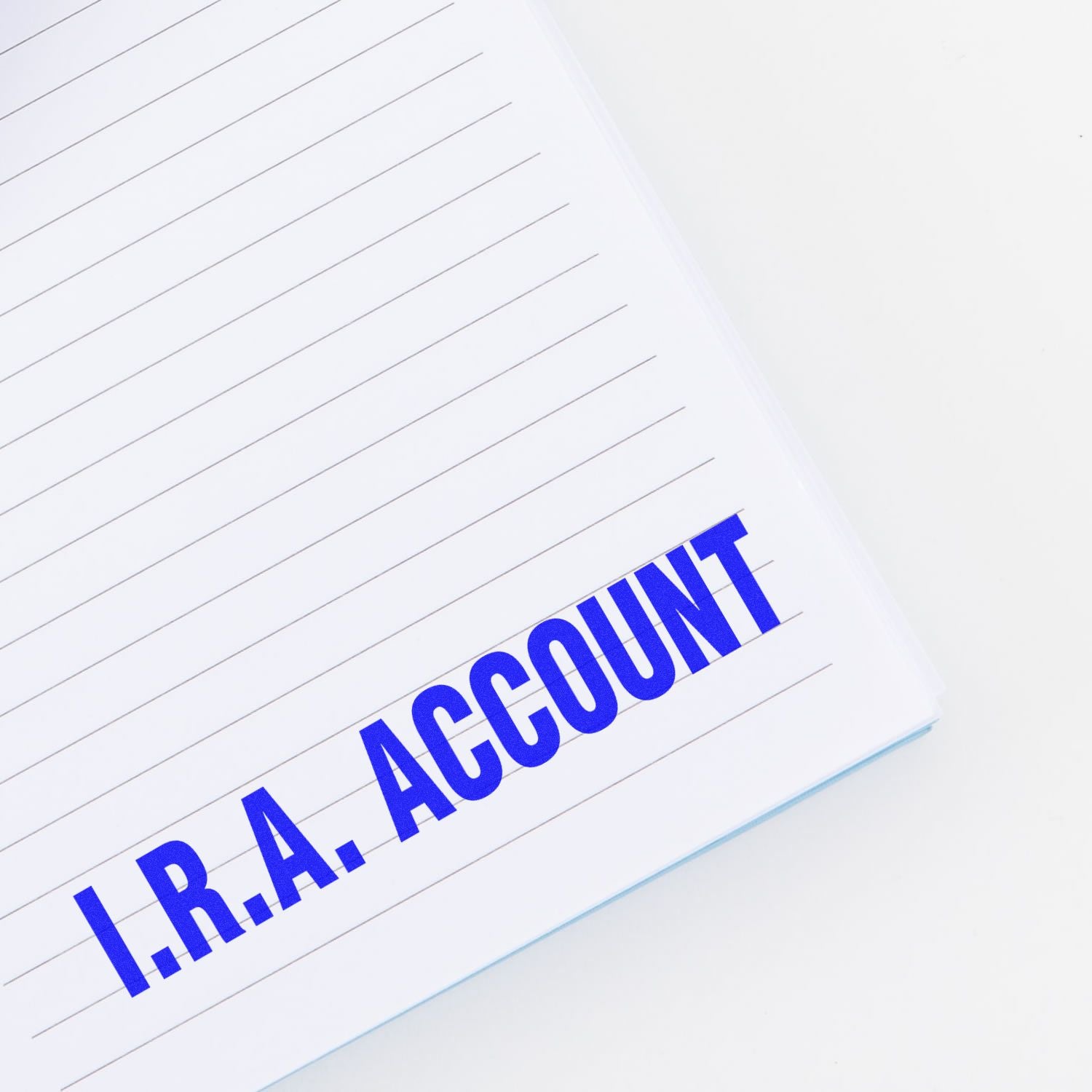 Notebook page stamped with 'I.R.A. ACCOUNT' in bold blue letters using the I.R.A. Account Rubber Stamp.